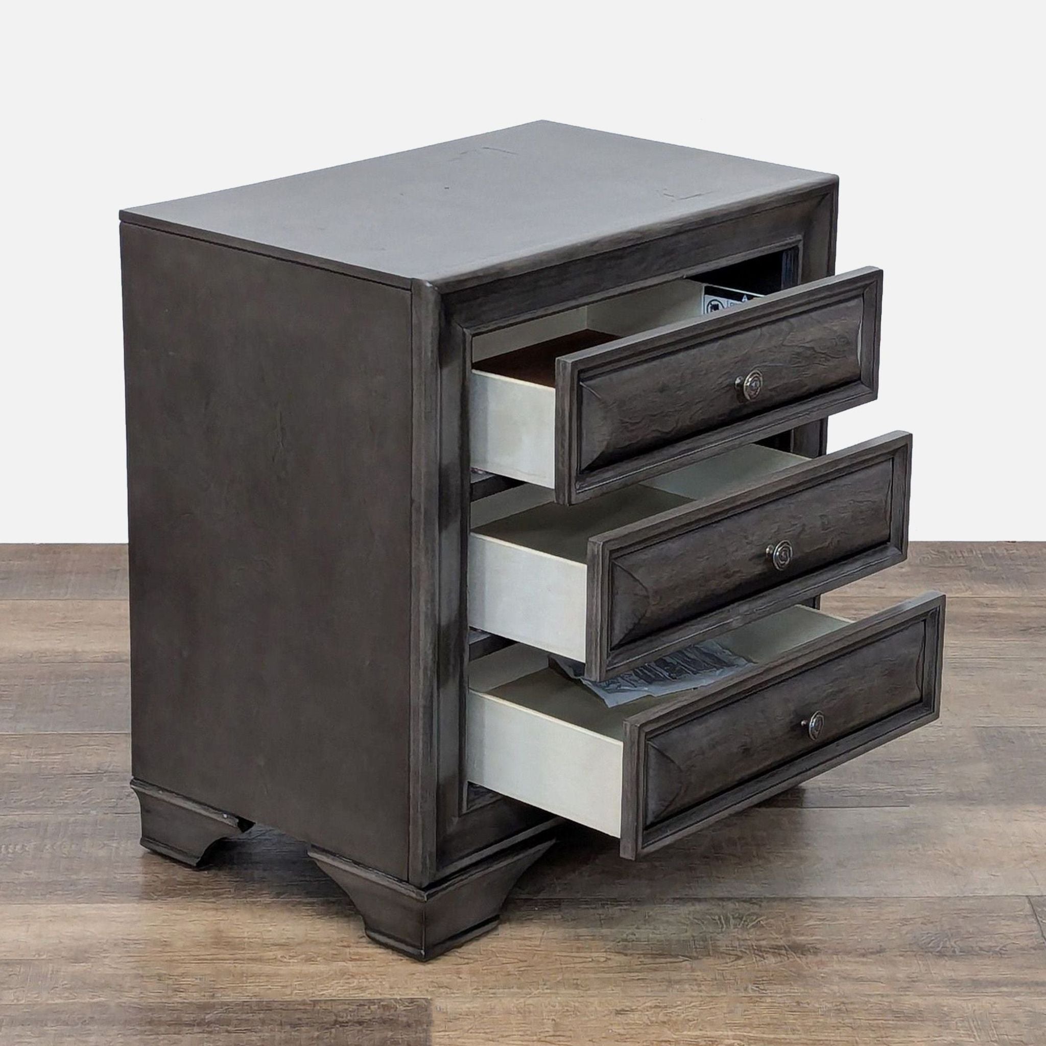Side view of Reperch end table showing open drawers and sturdy build.