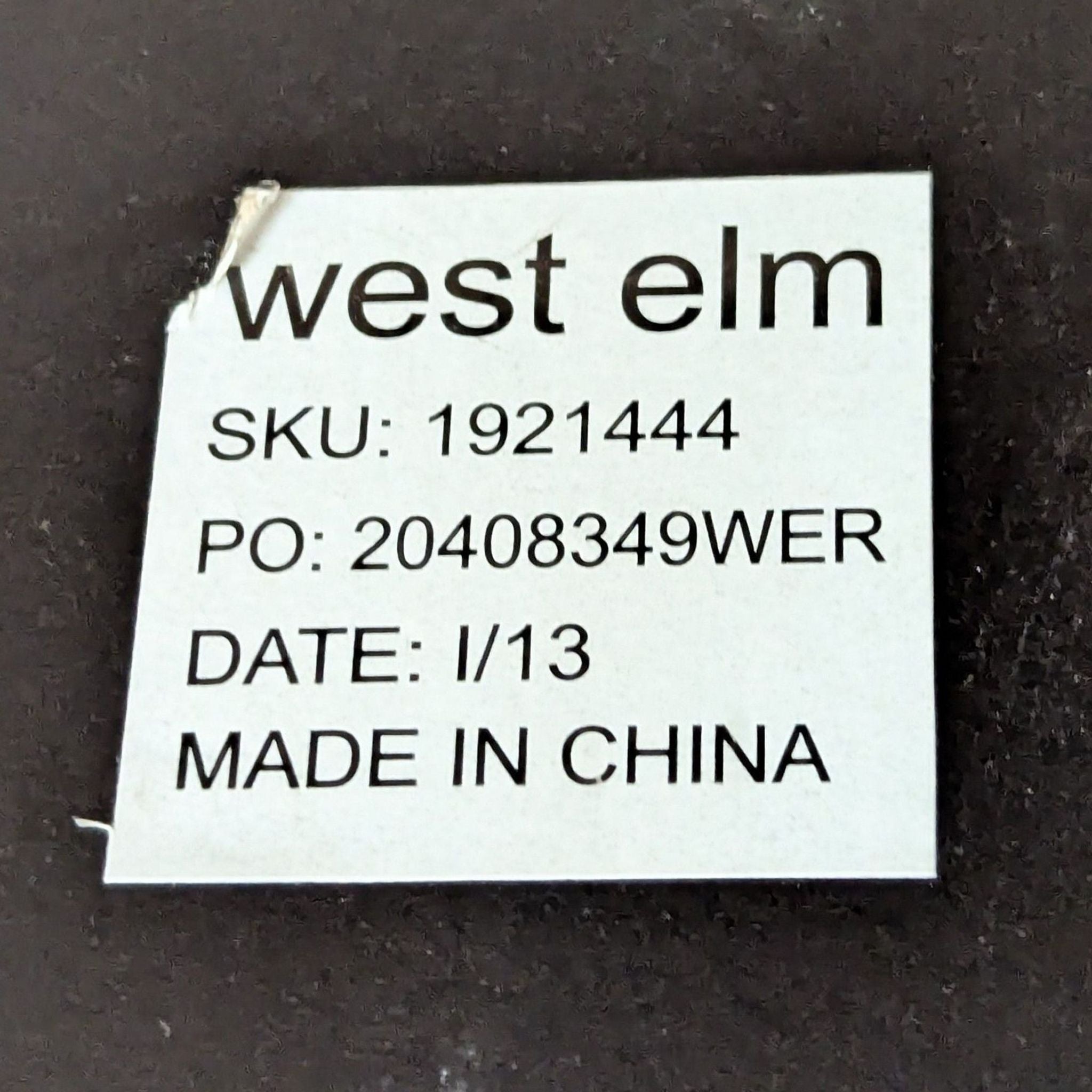West Elm product label with SKU 1921444, made in China, dated 1/13, displayed on the coffee table.