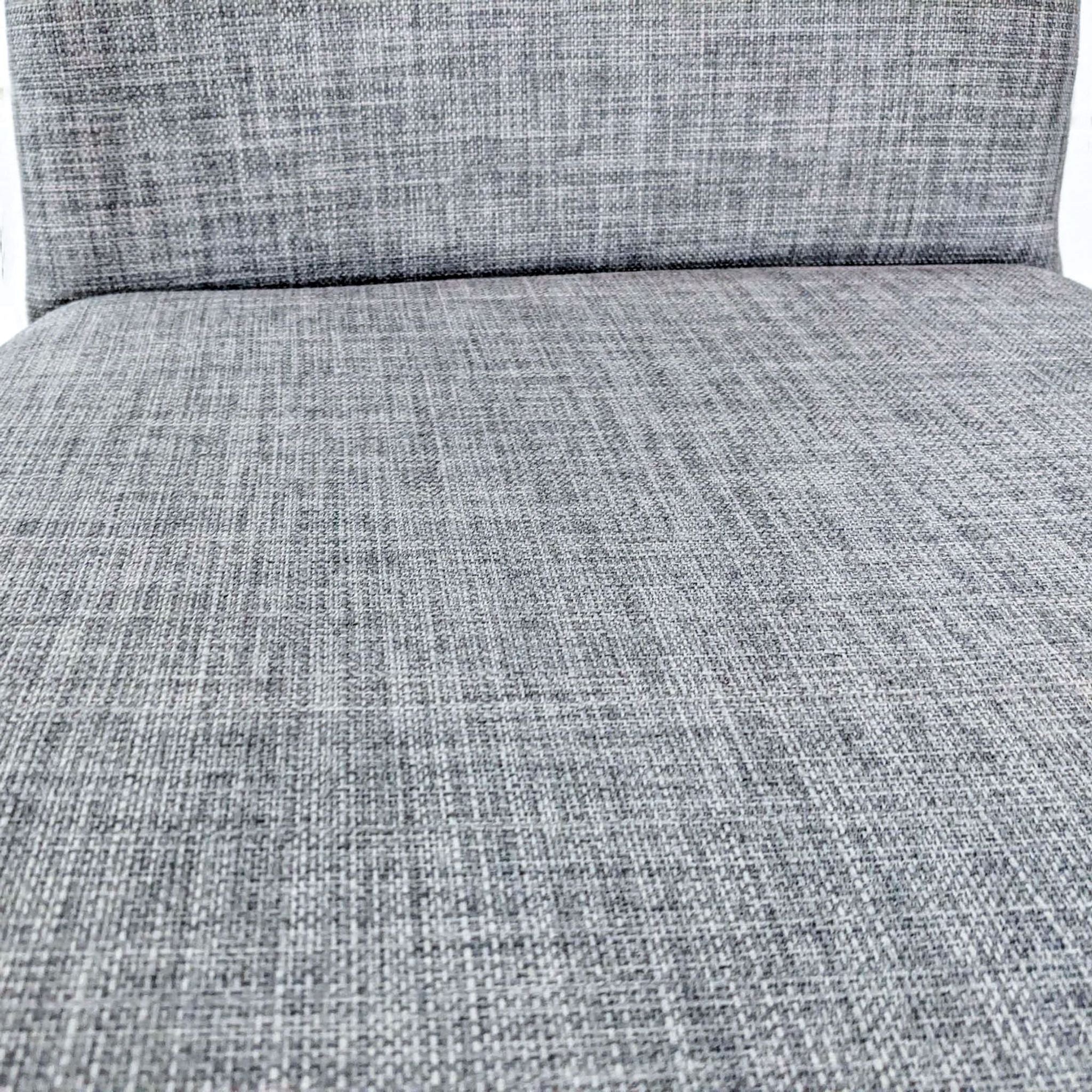 Alt text 2: Close-up of gray fabric texture on a Reperch upholstered meeting chair seat and backrest.