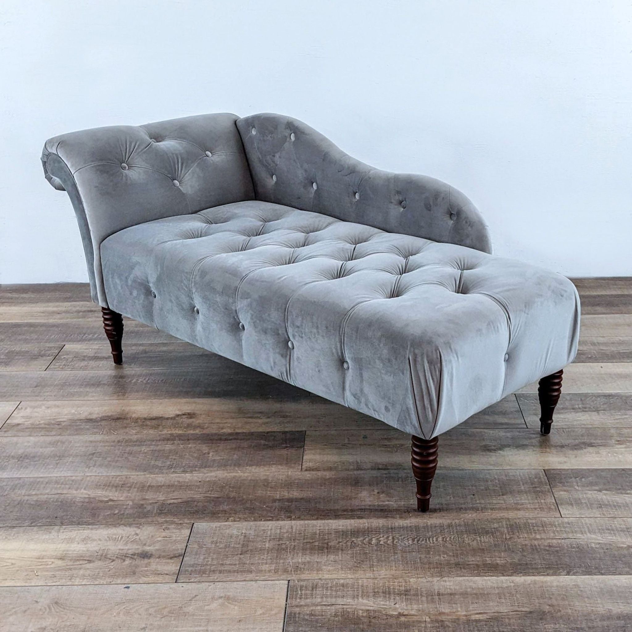 Alt text 1: A Kannon brand vintage-style tufted chaise lounge with curved back and wooden spindle legs on a wooden floor.