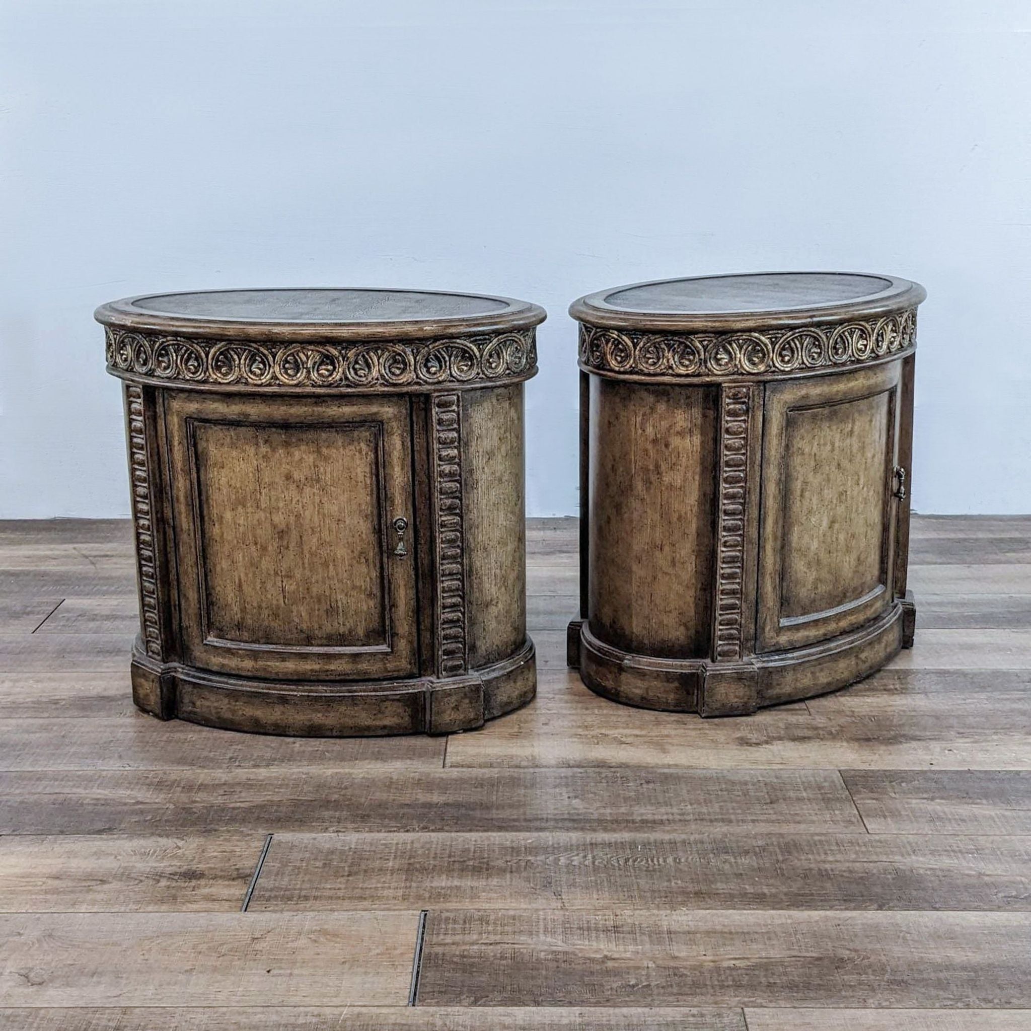 Antiqued, handcrafted end tables from The Platt Collection with a round top and ornate patterns.