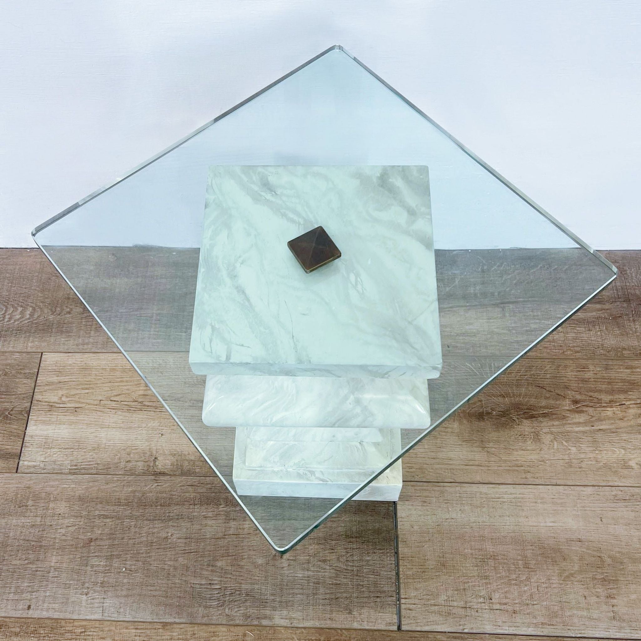 Reperch brand modern end table with a glass top and marble-look lower shelf on a wooden floor.