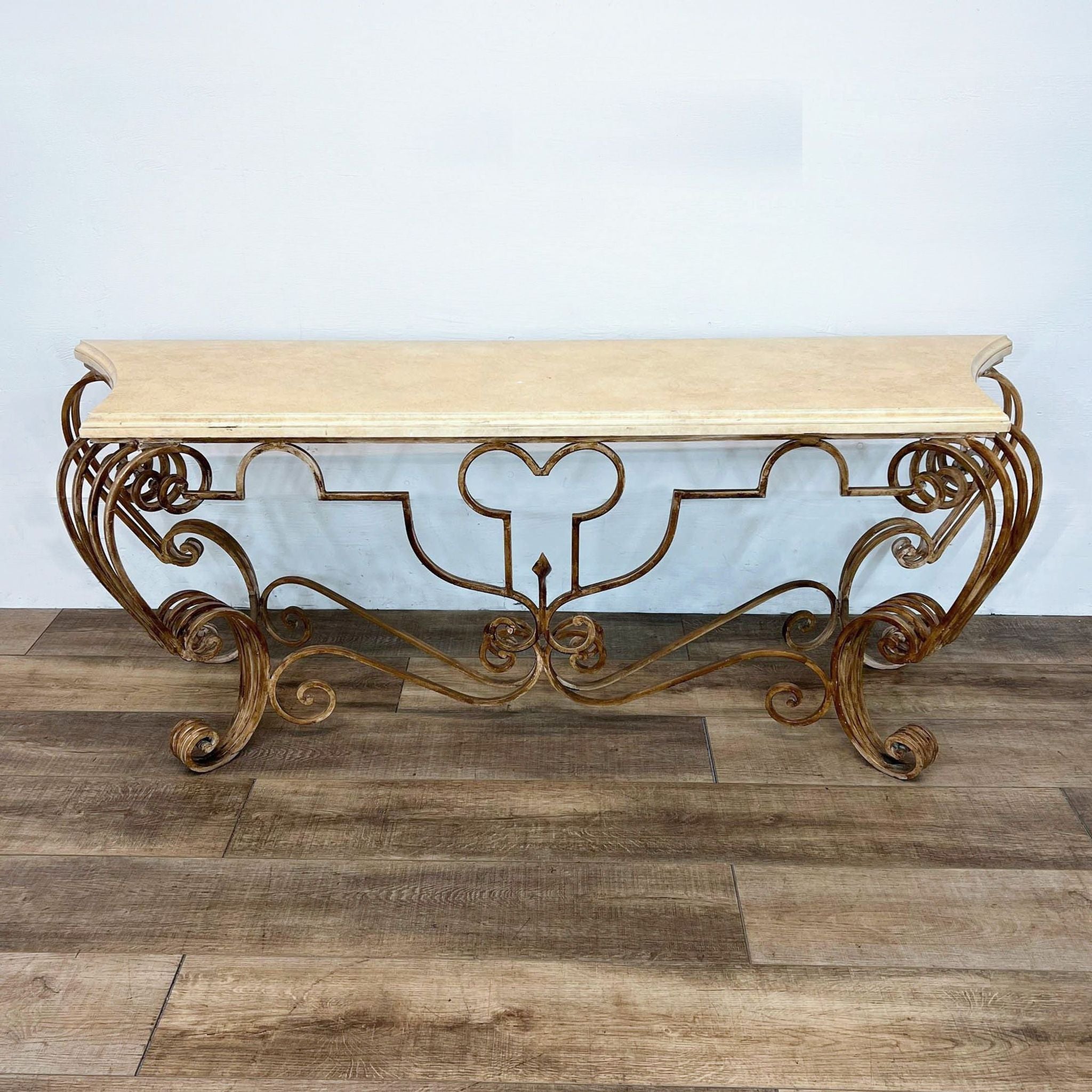 Reperch brand elegant console table with ornate gold-colored metal legs and a cream marble top.