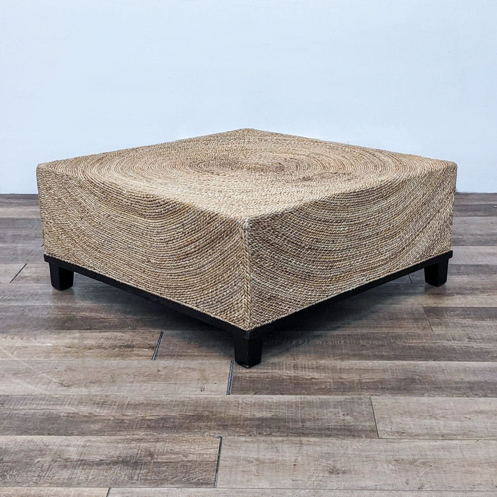 Hexagonal Reperch coffee table with natural fiber weaving and black legs.