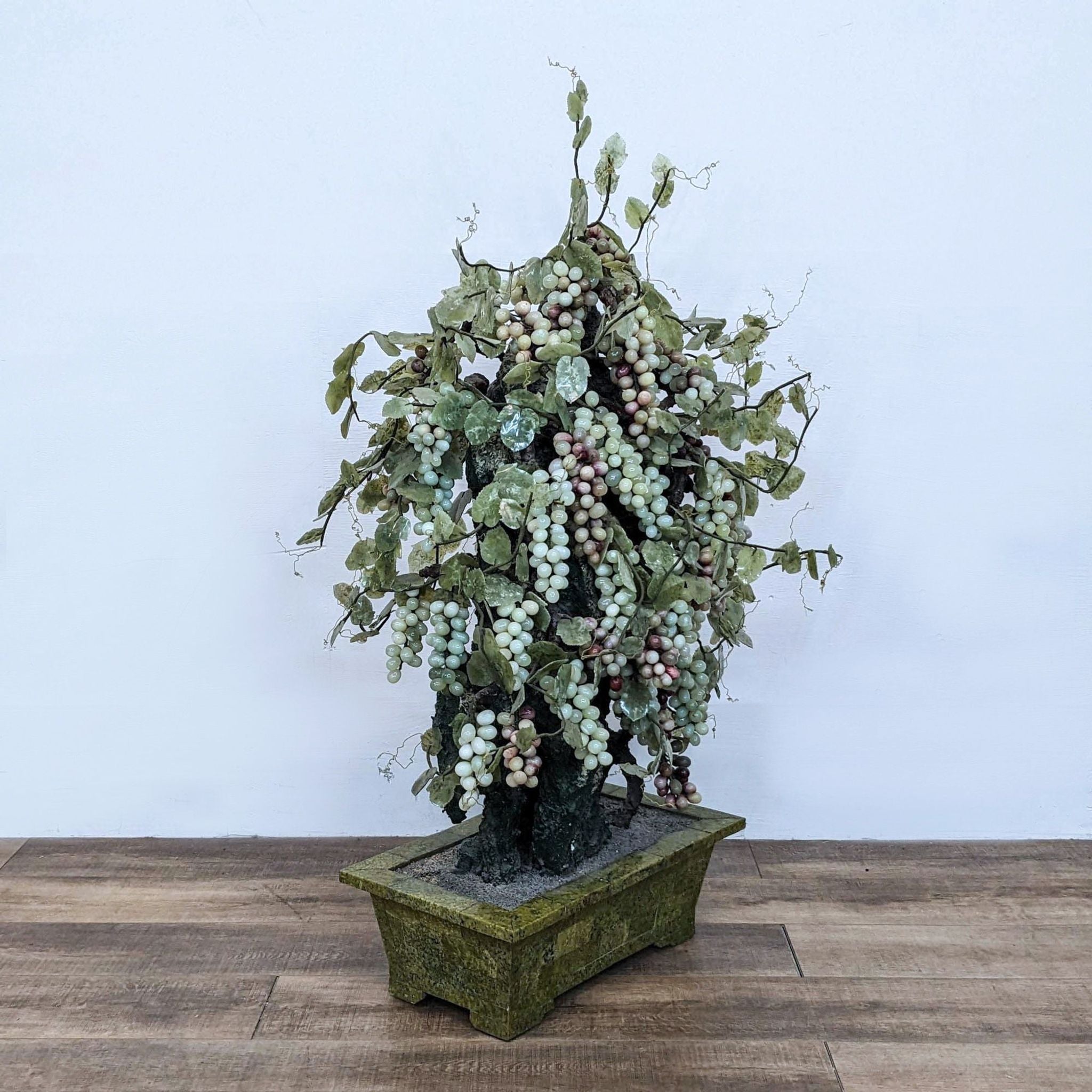 3. Full view of a tall artificial grapevine arrangement with abundant grape clusters, situated in a textured green square planter.