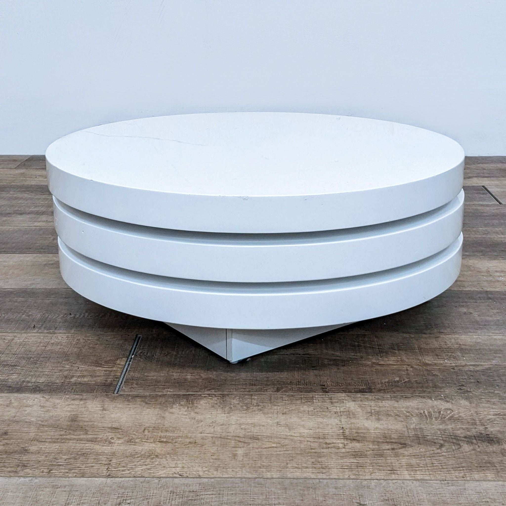 Round white high-gloss MDF coffee table by Moe's Home Collection with layered design on a wooden floor.