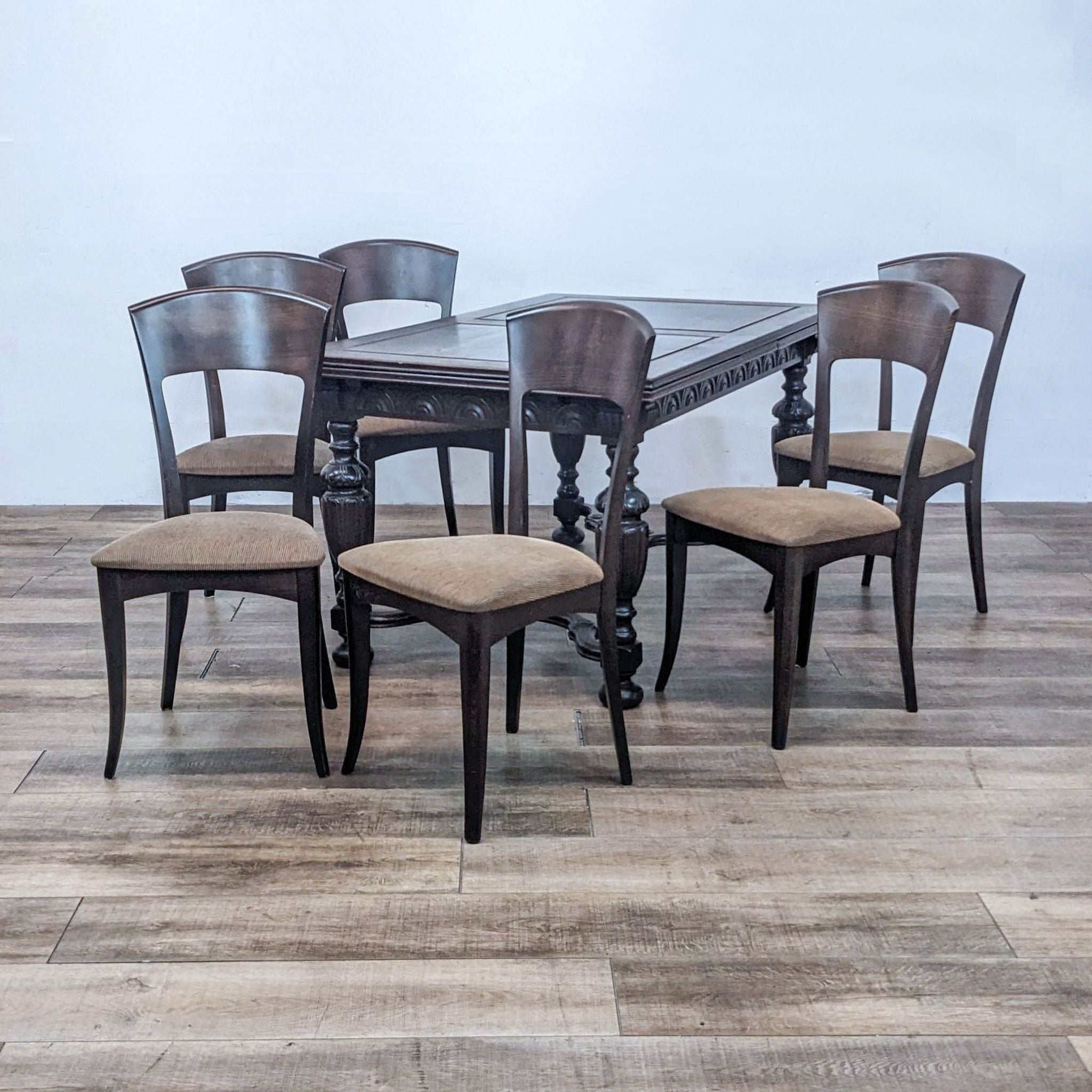 Antique solid wood table with 6 teak chairs by A. Sibau, featuring black upholstery and mid-century design.