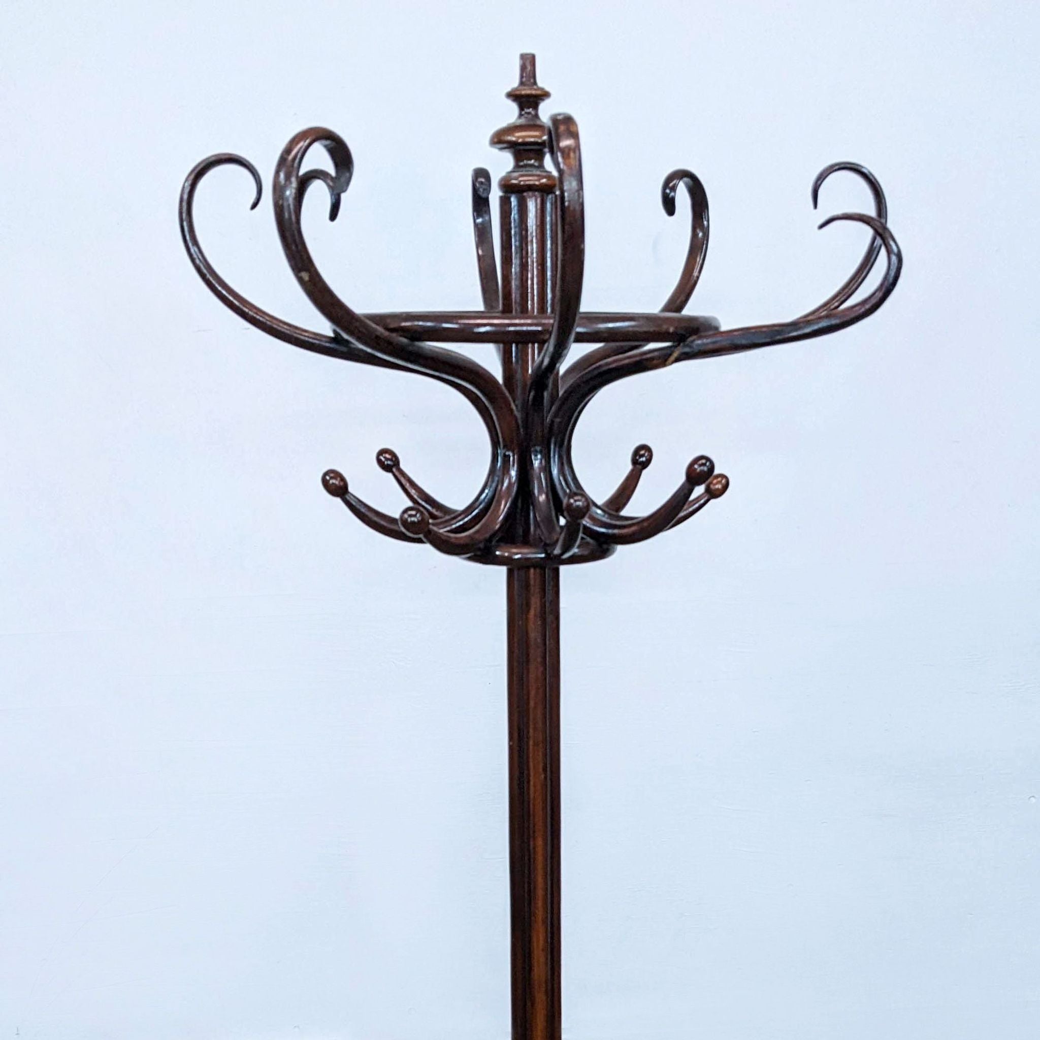 Alt text 2: Close-up of a Thonet wooden coat rack showcasing the bent wood design and craftsmanship, with a focus on the curved legs and S hooks.