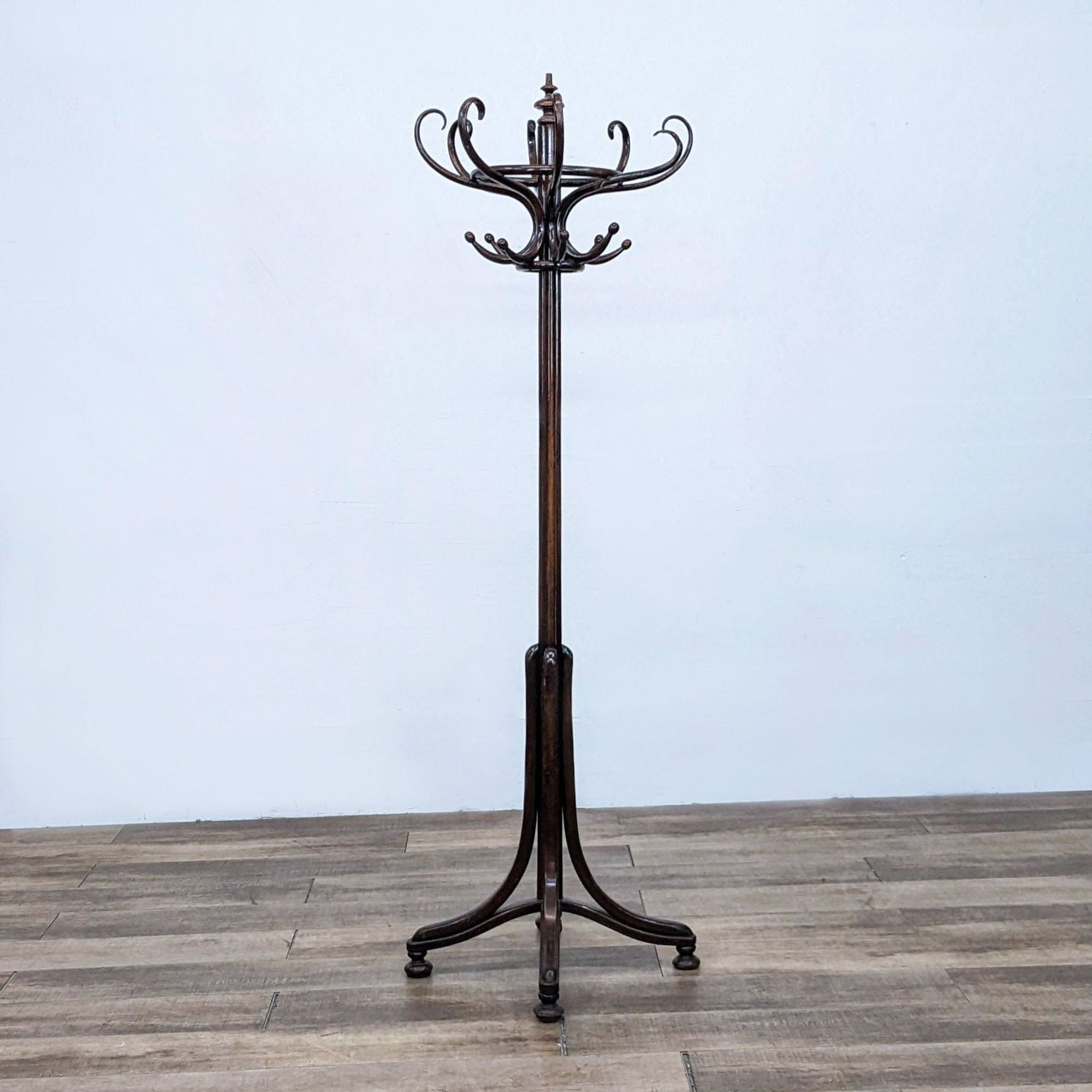 Alt text 1: Antique Thonet art nouveau wooden coat rack with eight intricate S hooks on a decorative top, standing on a three-legged base.