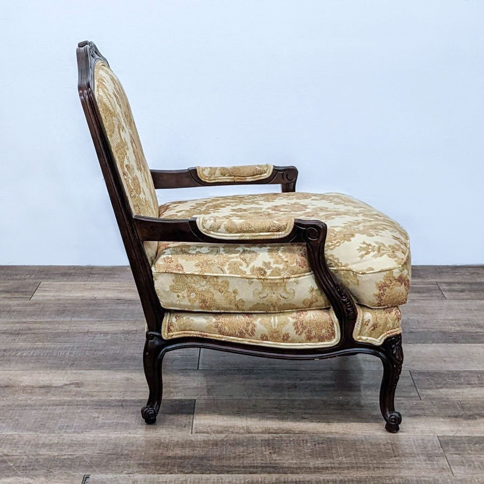 Side view of Thomasville Patriarch accent armchair showing detailed wood carving and patterned upholstery.