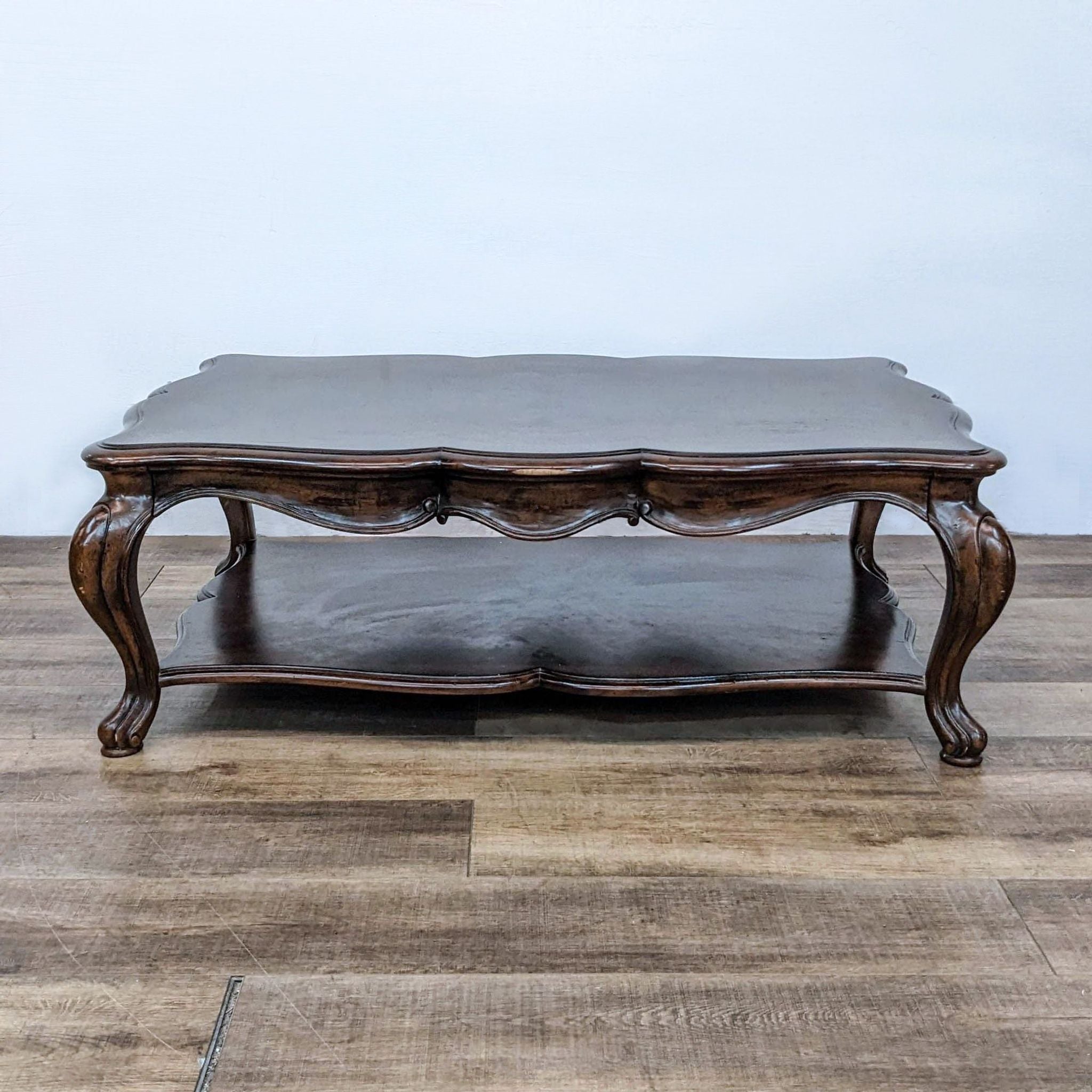 Thomasville serpentine coffee table with elegant cabriole legs and inlaid wood top design.