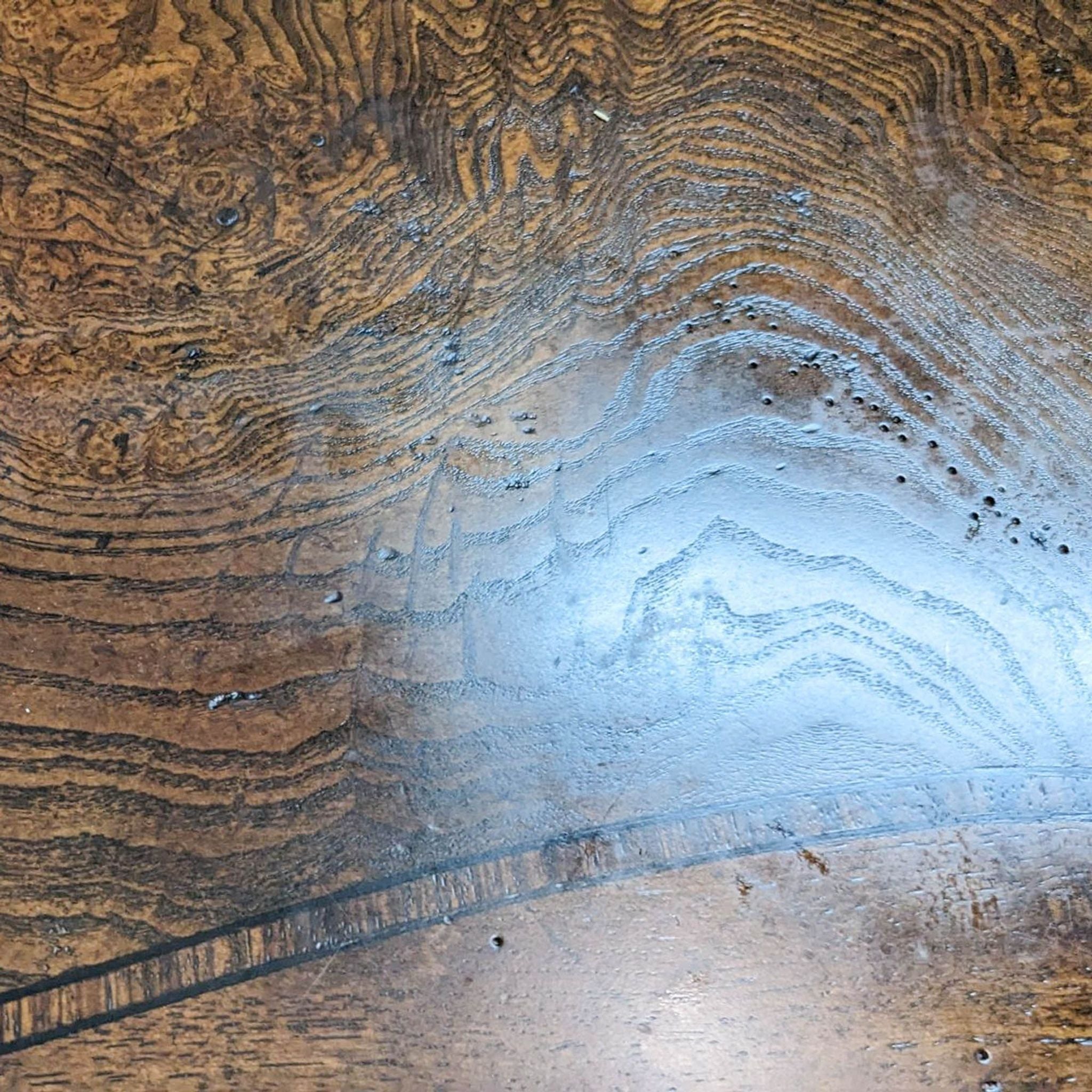 Close-up of inlaid wood pattern on Thomasville coffee table showcasing intricate grain details.