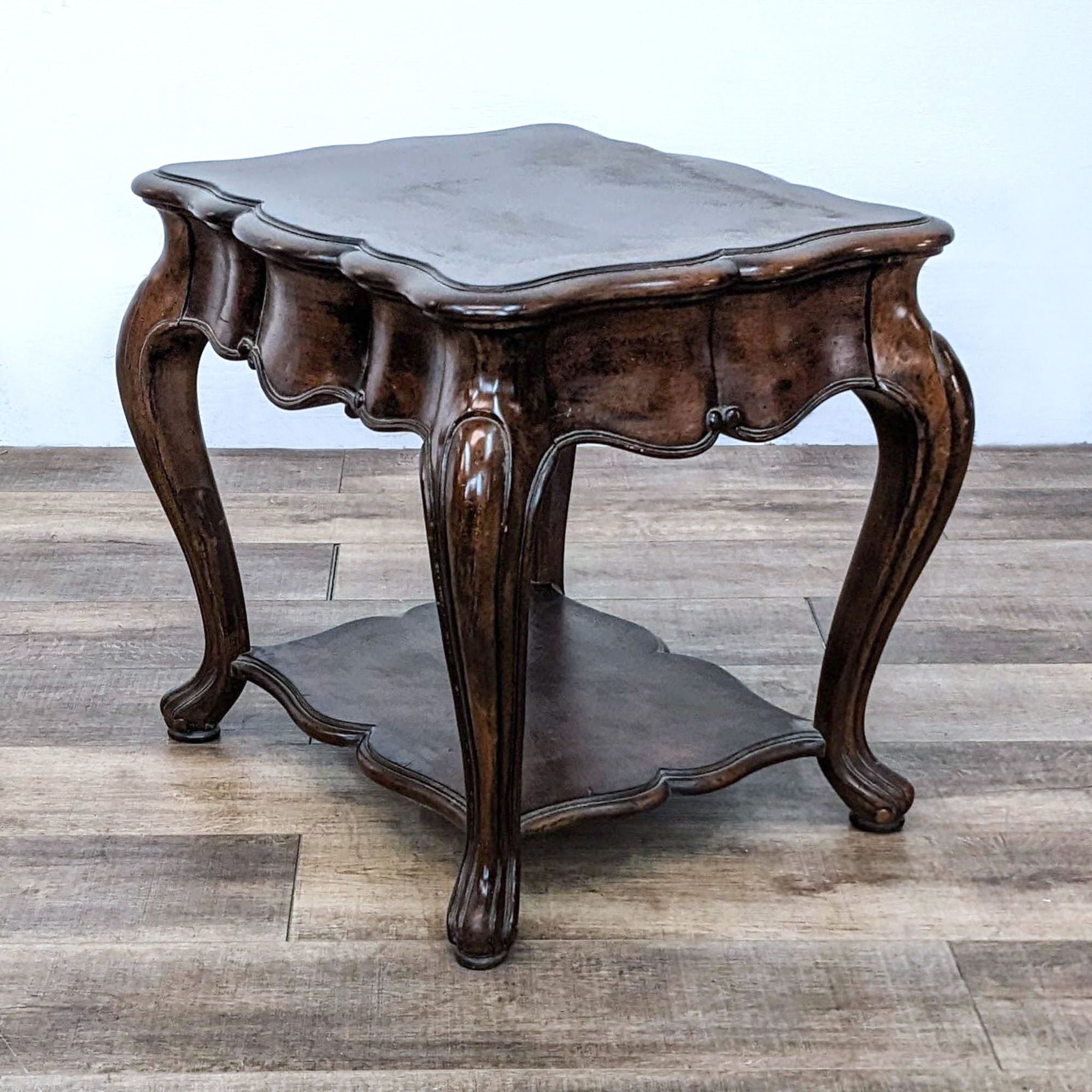 Alt text 2: Image of a wooden Thomasville branded end table with a scalloped surface, elegant legs, and a shelf below.