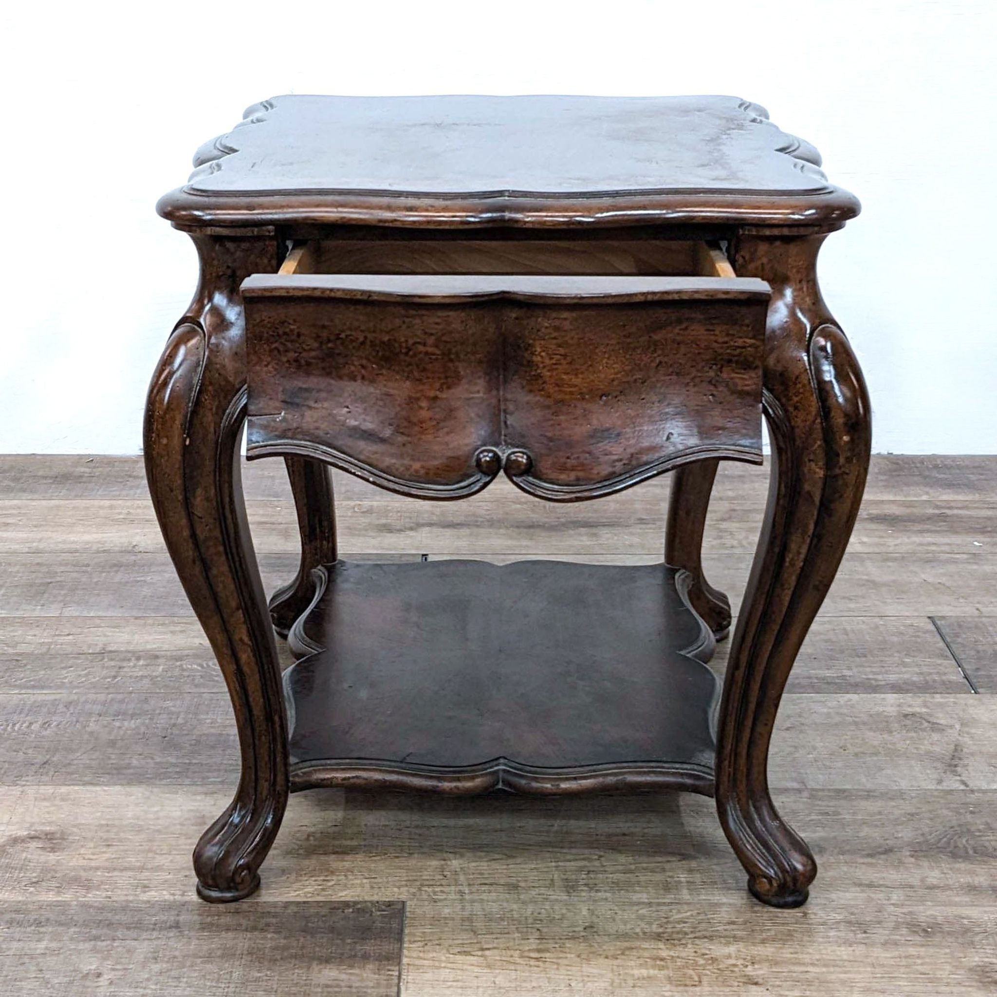 Alt text 1: Thomasville serpentine end table with inlaid top, curvy cabriole legs, and lower shelf, on wooden floor.