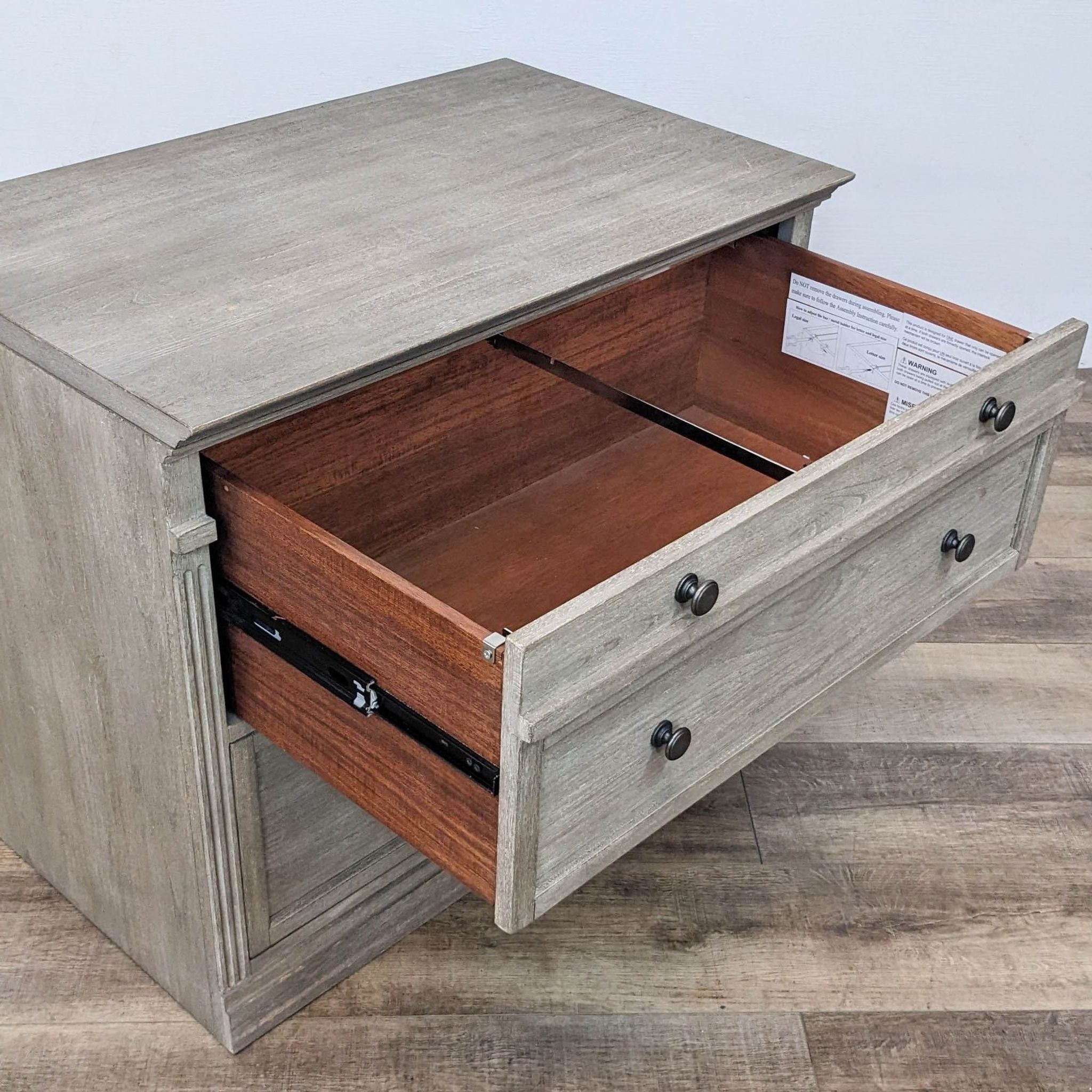 Open drawer view of Livingston file cabinet by Pottery Barn, displaying English dovetail joinery and ball bearing glides.