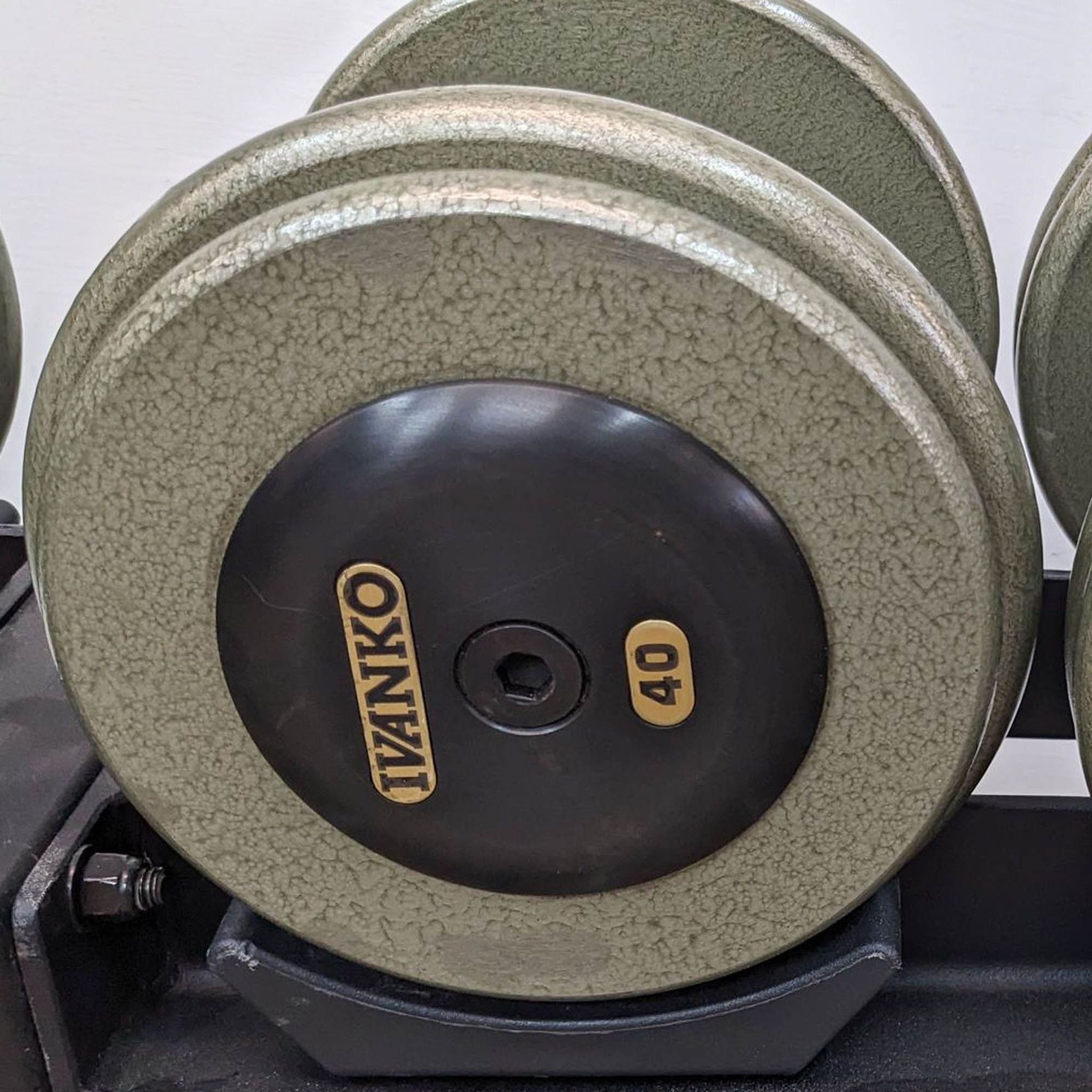 Close-up of a 40-pound Ivanko dumbbell on a rack, highlighting the textured finish and brand logo.