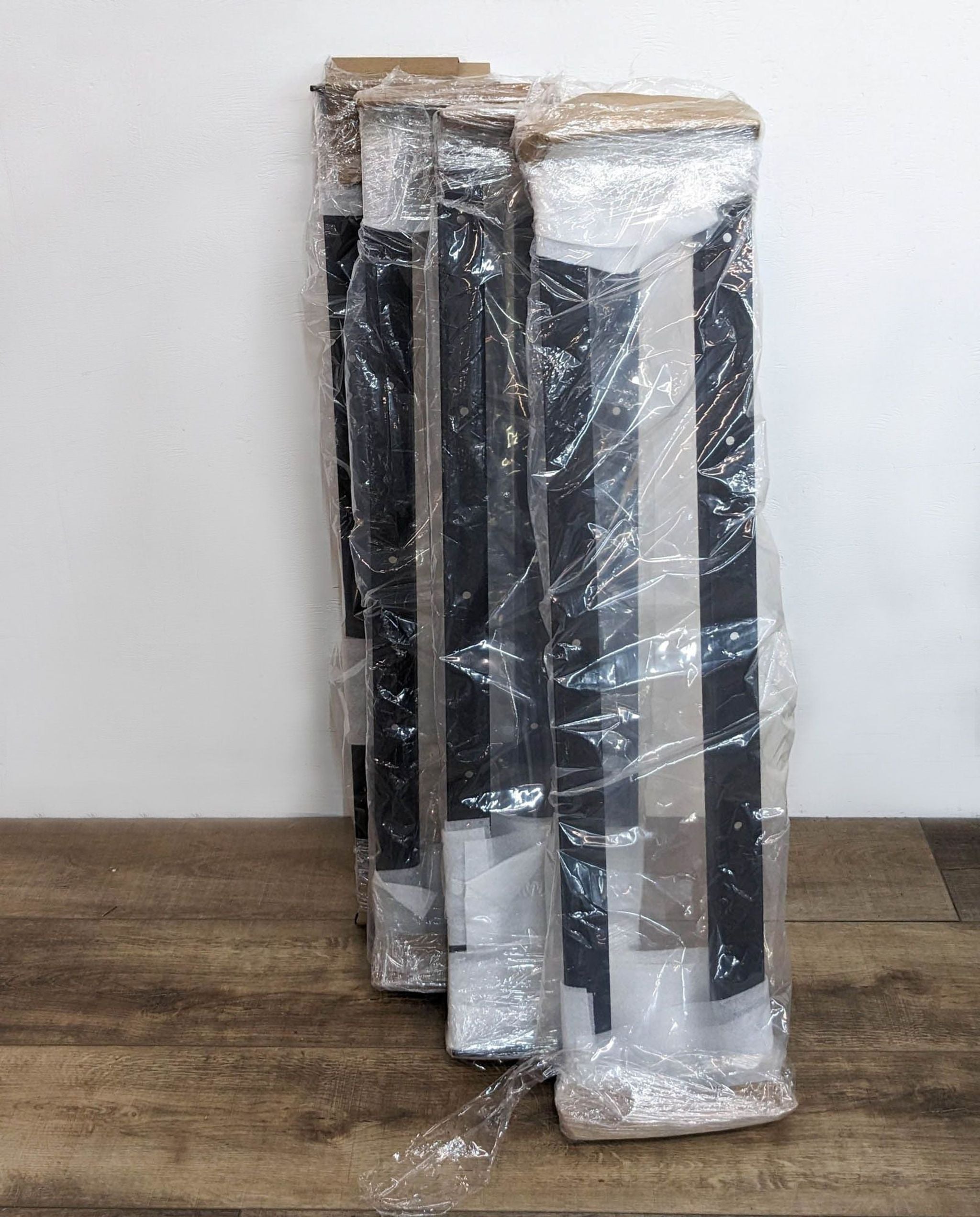 Image 2: Ivanko gym equipment parts wrapped in plastic and foam packaging, ready for assembly or shipment.
