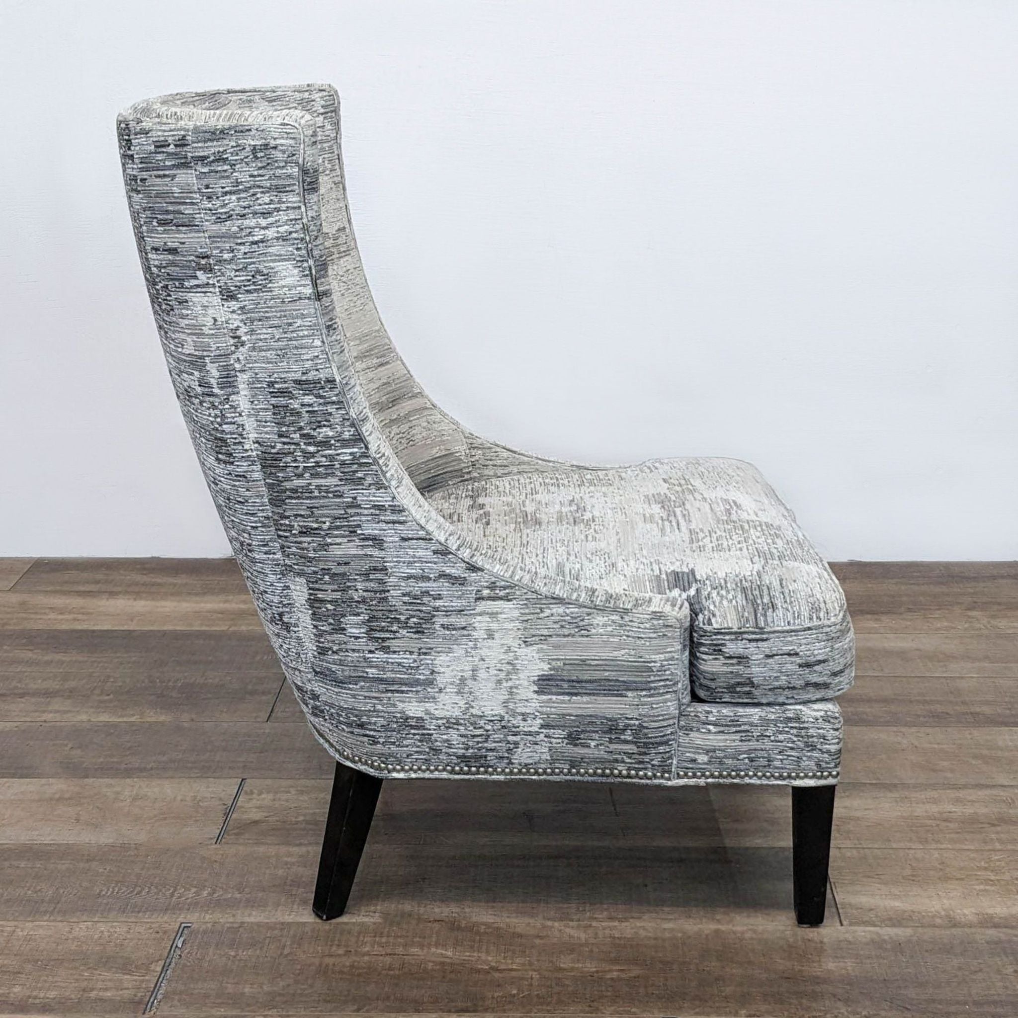 HD Buttercup lounge chair featuring upholstery, silver detailing, and hardwood legs, front view.