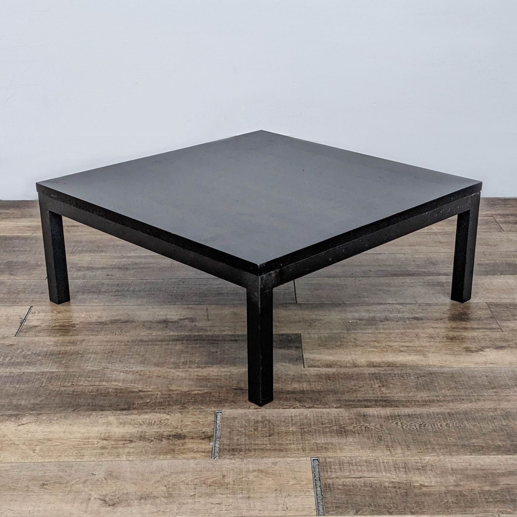 Minimalistic black Parsons coffee table by Room & Board in an interior setting.