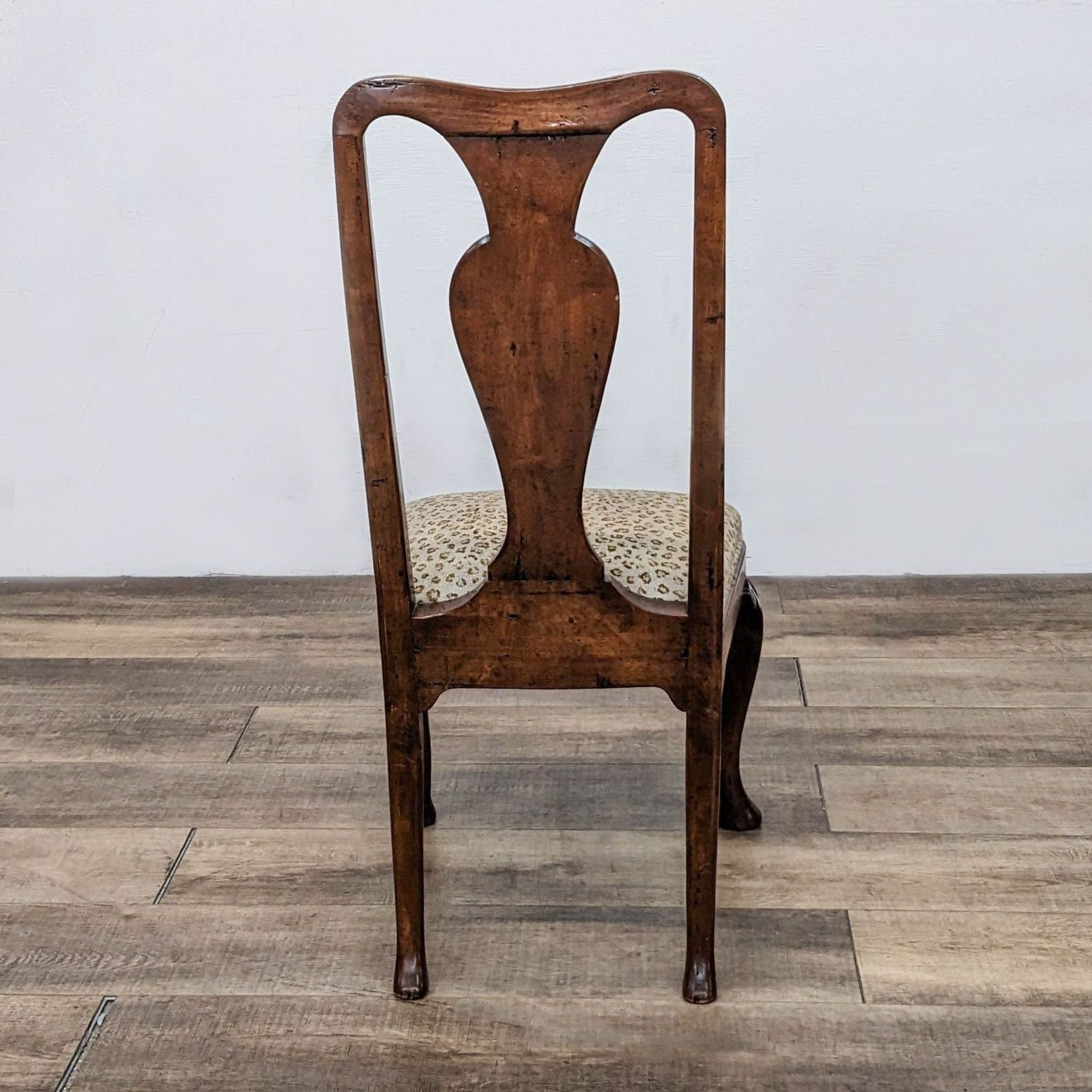 Queen Anne style Reperch dining chair with wooden frame and leopard print upholstered seat against a neutral background.