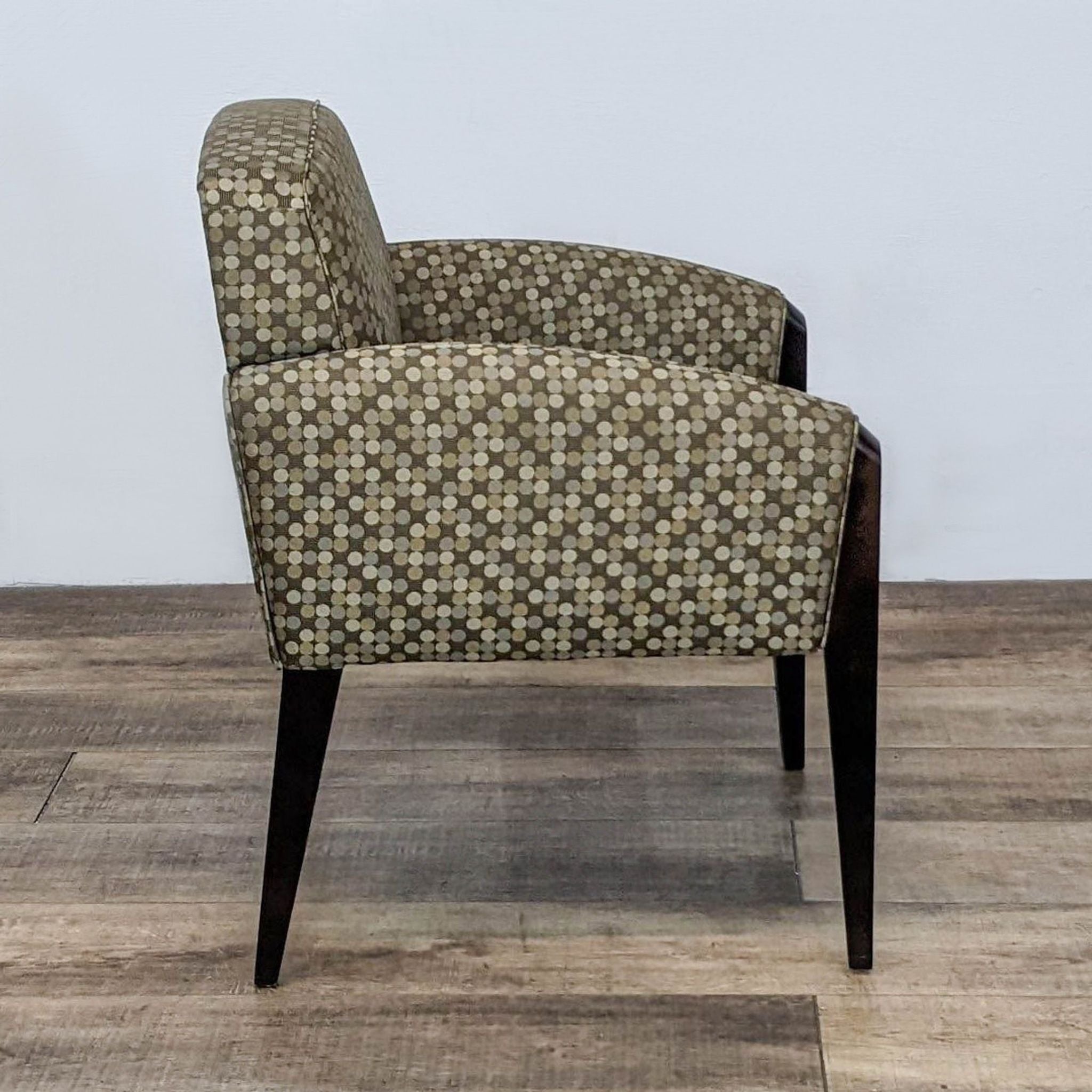 Side view of a contemporary Haworth Galerie lounge chair with a geometric pattern and sleek wood legs.
