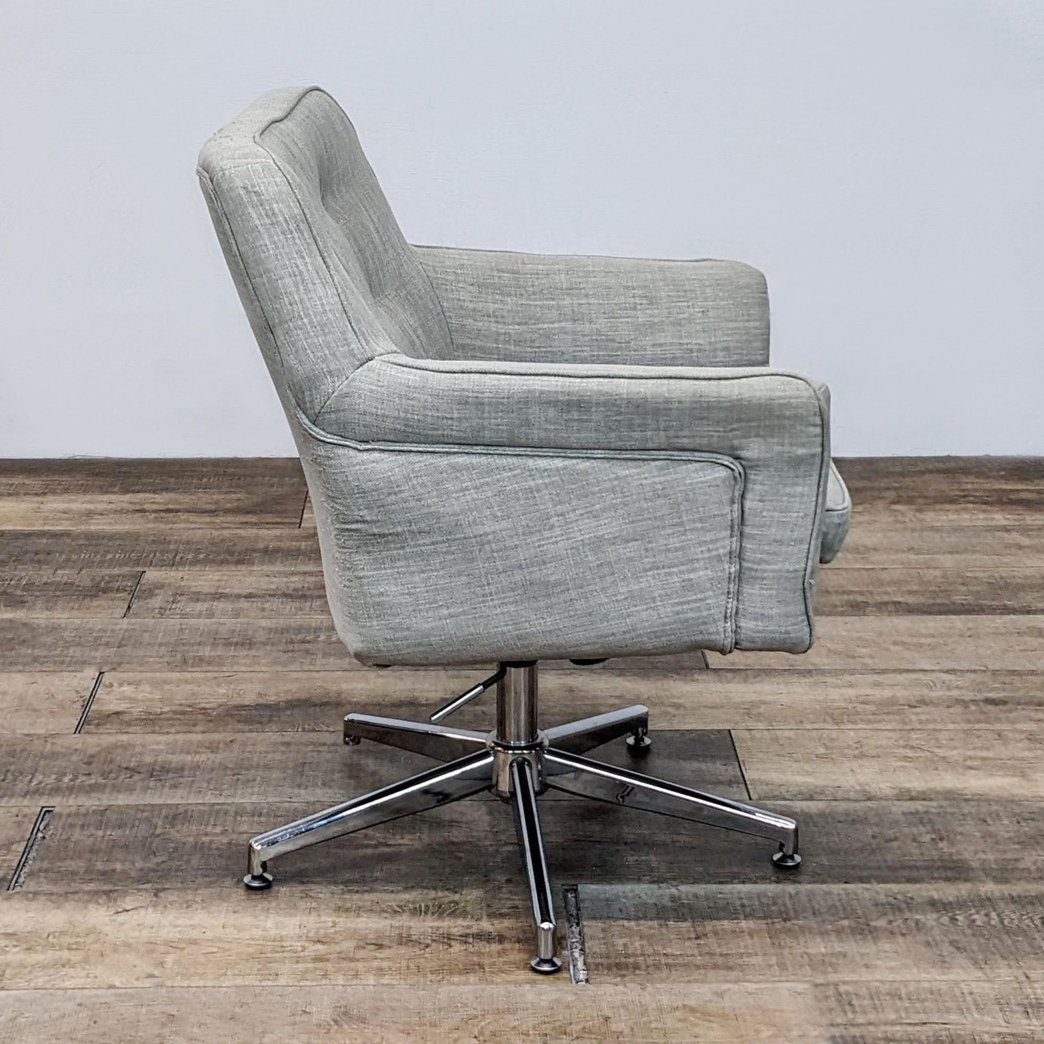 Reperch textured linen armchair, tufted back, side view on a five point chrome base with swivel and height adjustment.