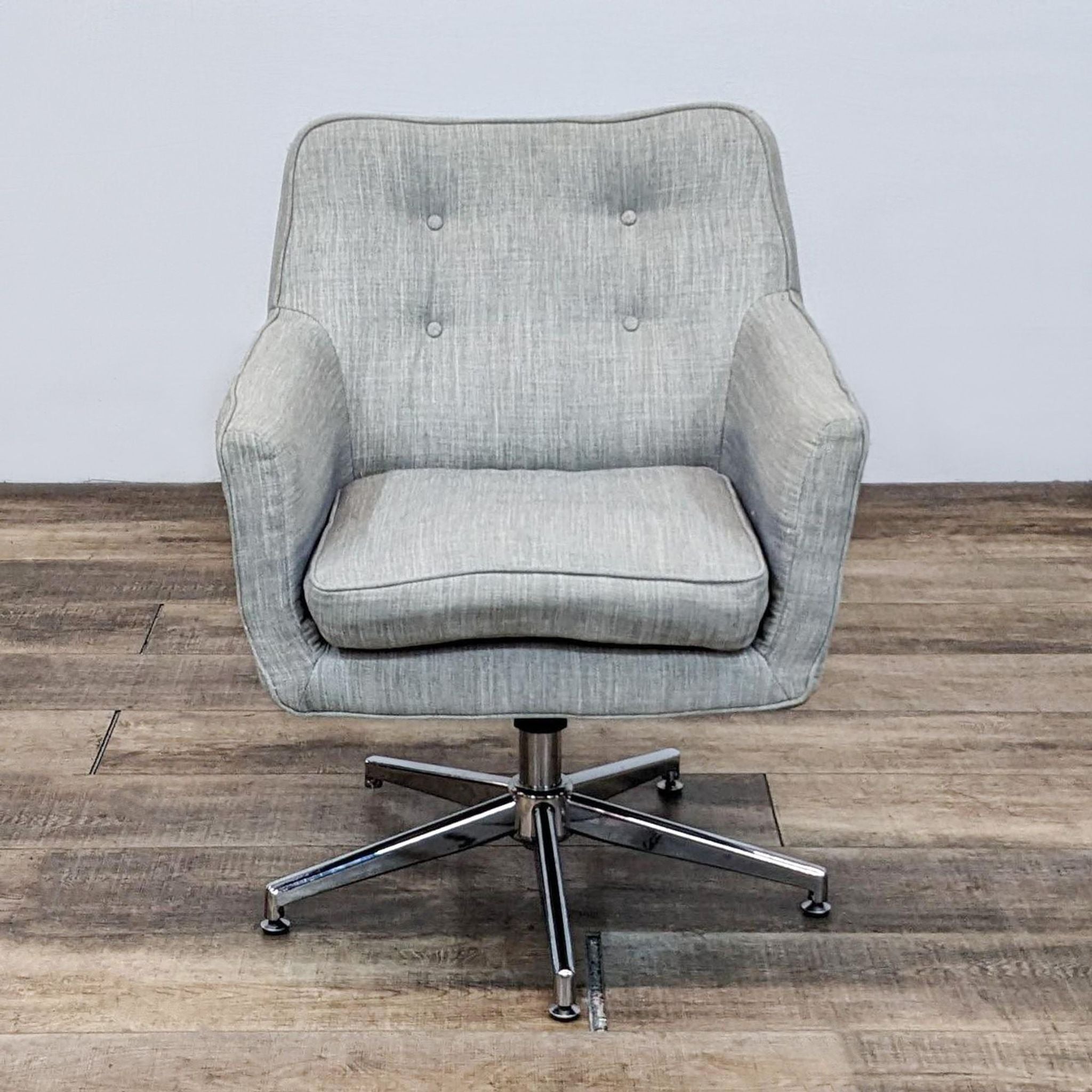 Reperch linen fabric upholstered armchair with button tufting and adjustable chrome swivel base, front view.
