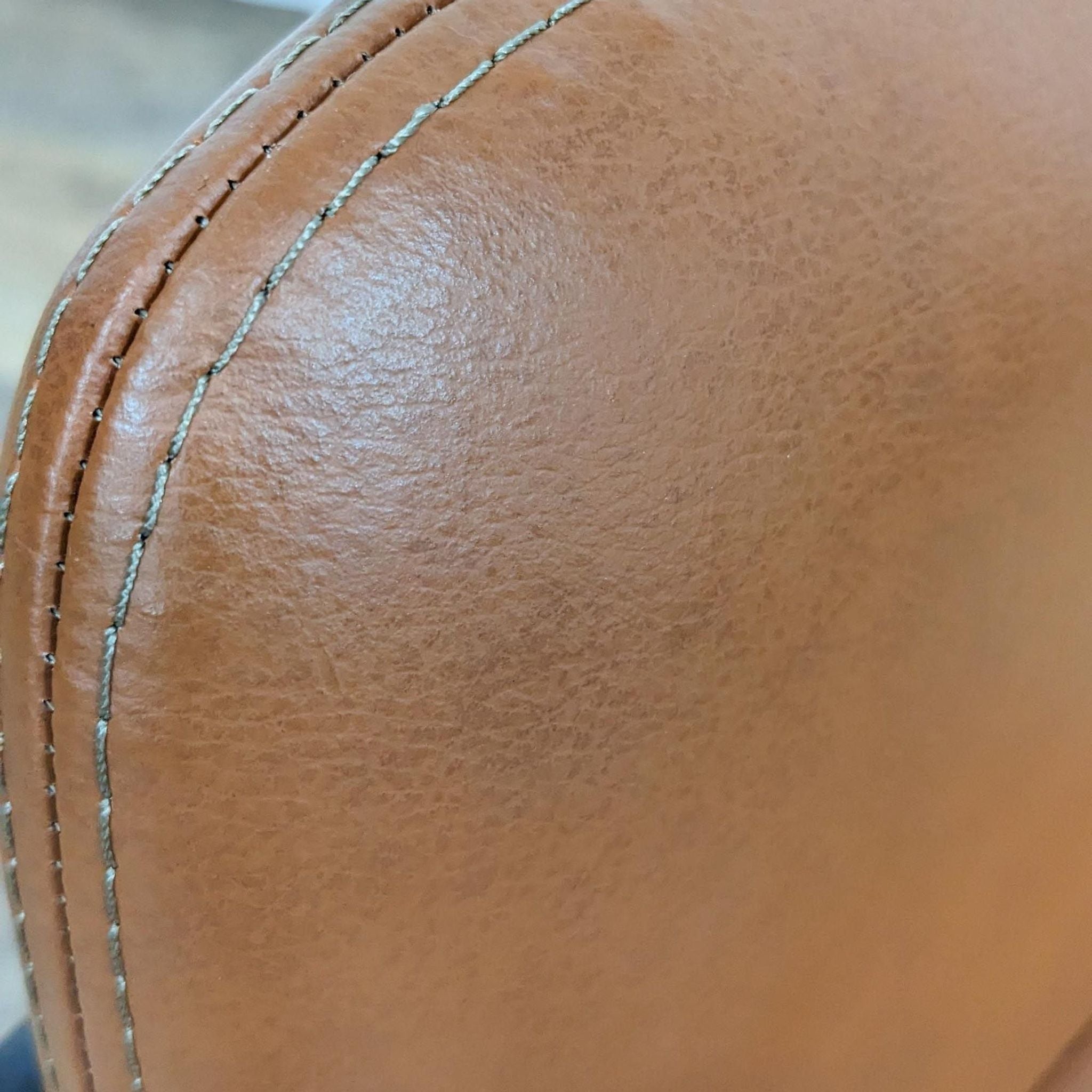 Close-up of a Reperch modern dining chair's vegan leather with detailed stitching.
