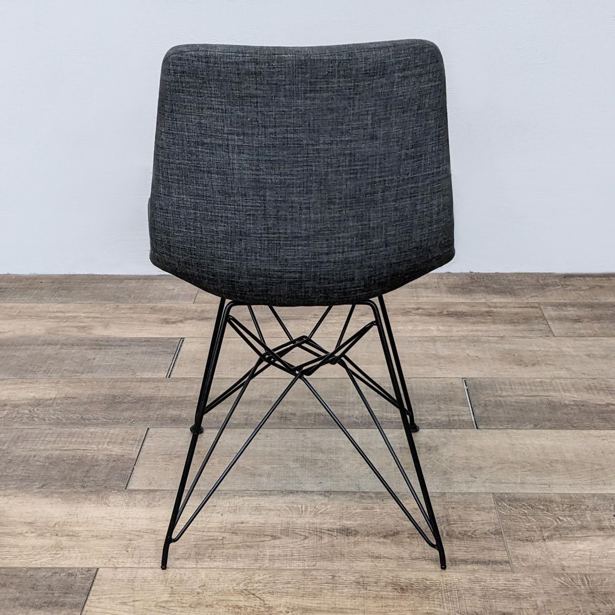 Armen Living's Palmetto Chair featuring black metal frame and grey fabric upholstery, for dining room use.