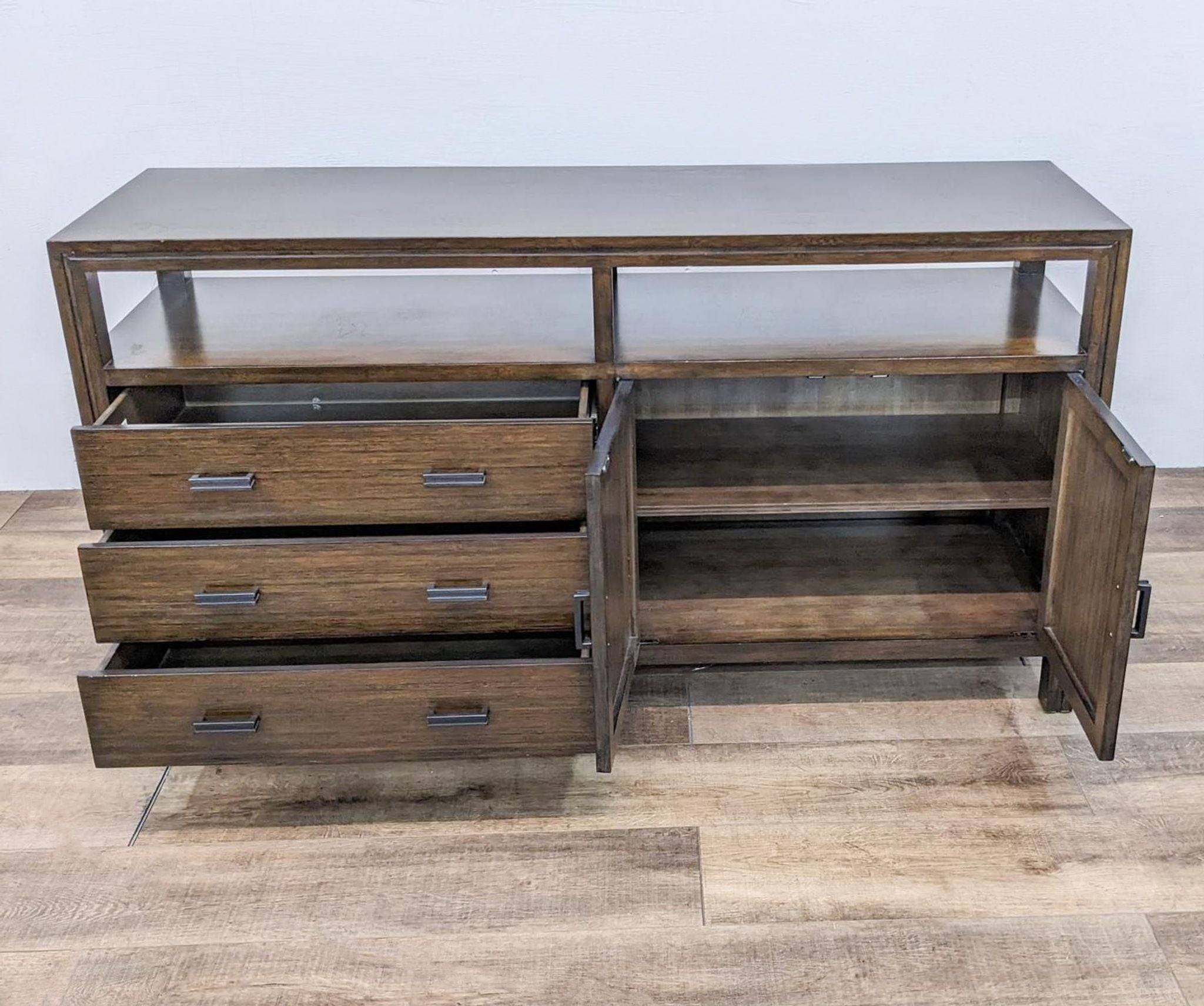 Crate & Barrel entertainment center, showing open drawers and a cabinet, on a wooden floor.