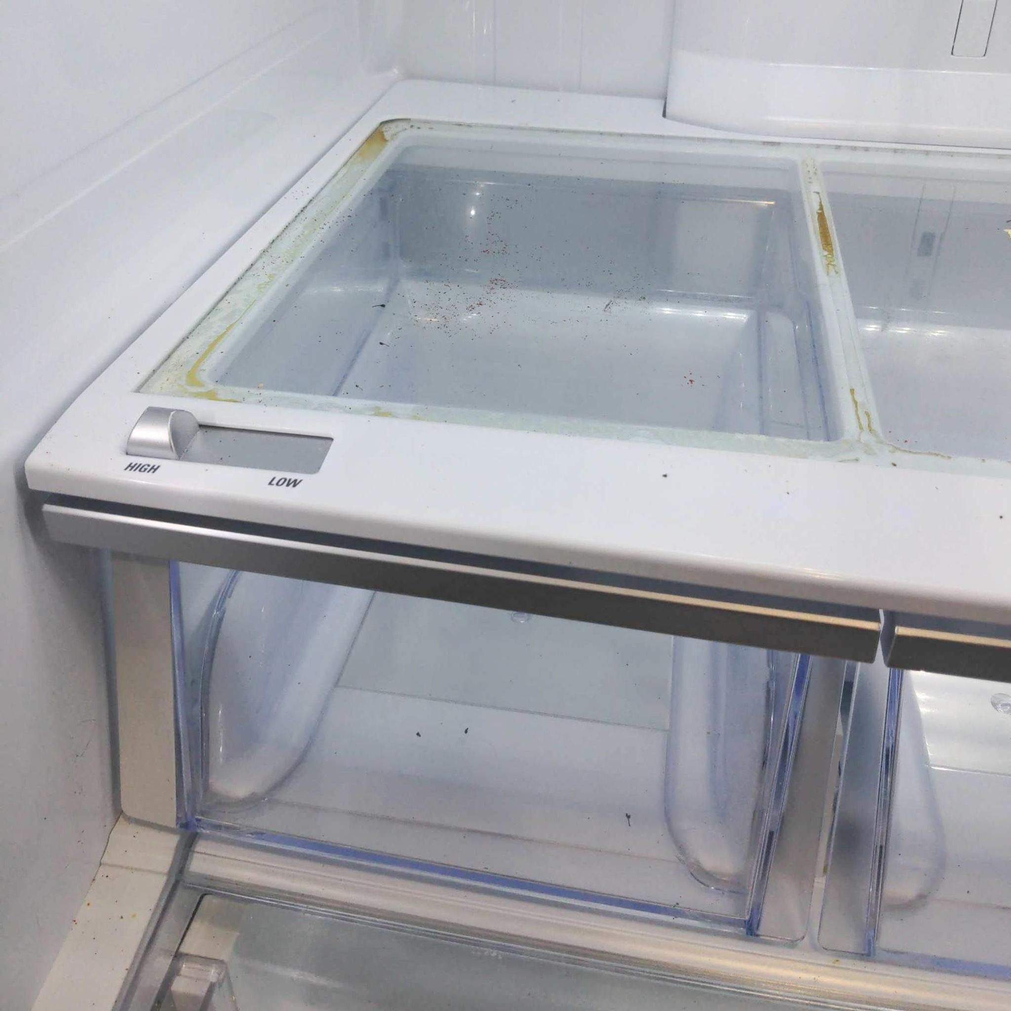 3. Interior of an LG refrigerator showing dirty glass shelves with crusted stains and spill residue.