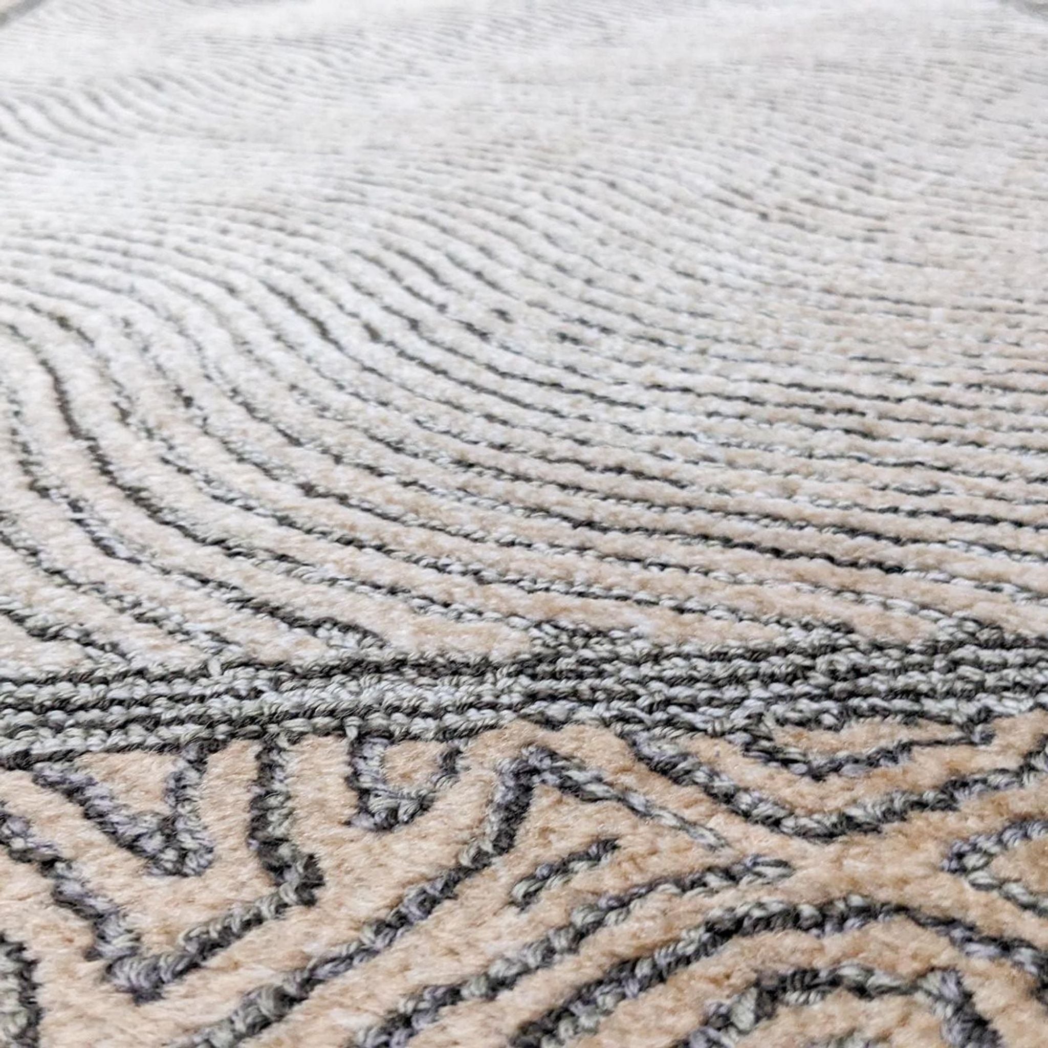 Close-up of medium pile hand knotted Reperch rug showing texture and neutral color detail.