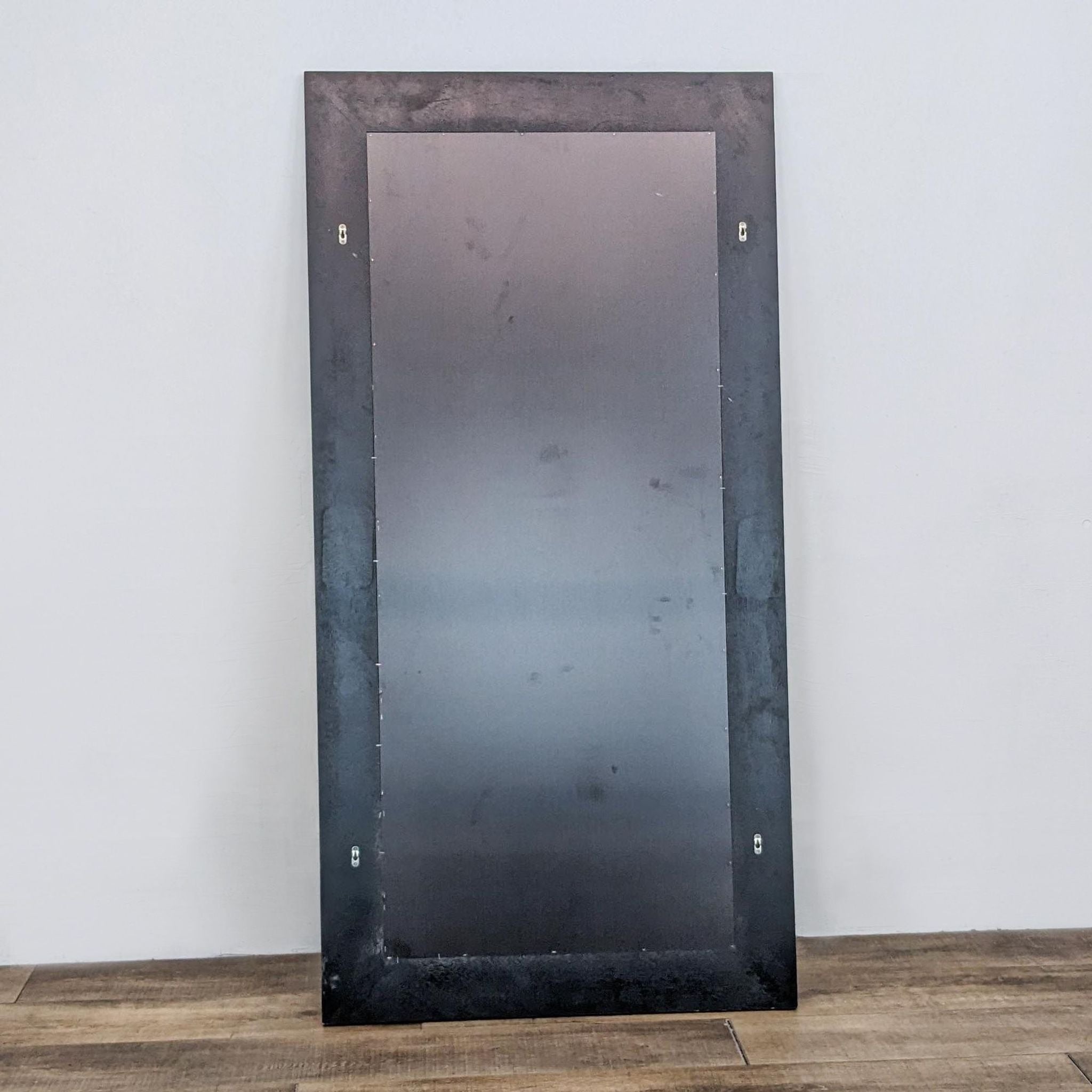 Modern Reperch mirror featuring black frame, installed in a room, close-up of sturdy frame detail visible.