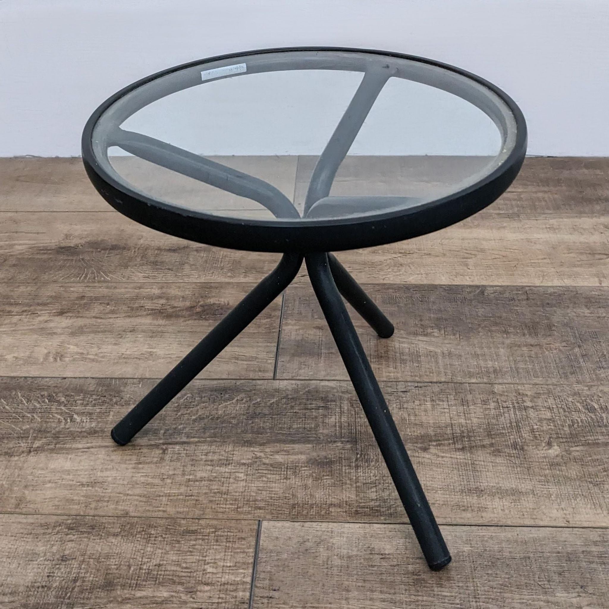 Three-legged Brown Jordan designer glass top table, 18 inches, with an aluminum frame against a plain backdrop.