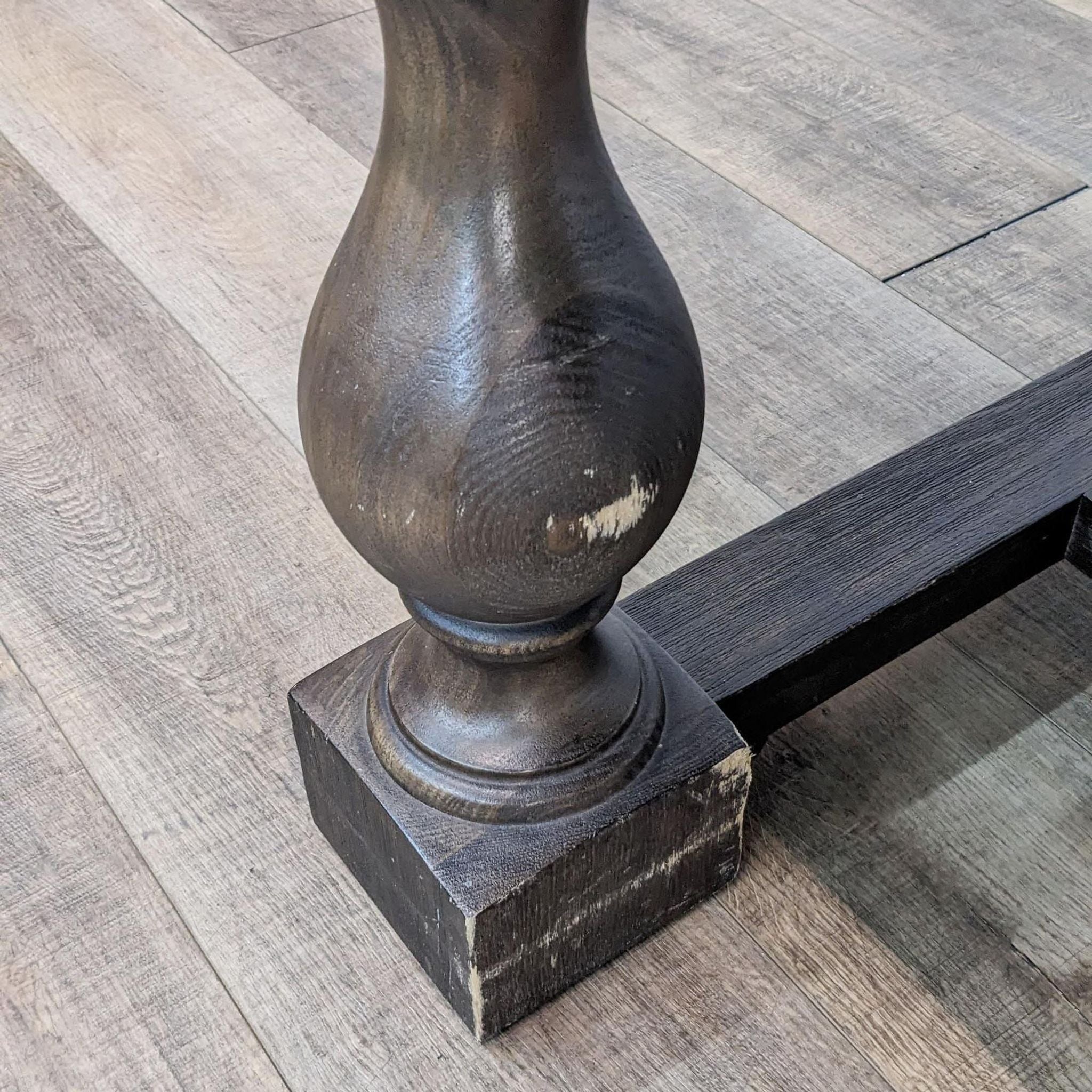 Close-up of Restoration Hardware dining table leg, showcasing lathe-turned baluster design and traditional joinery.