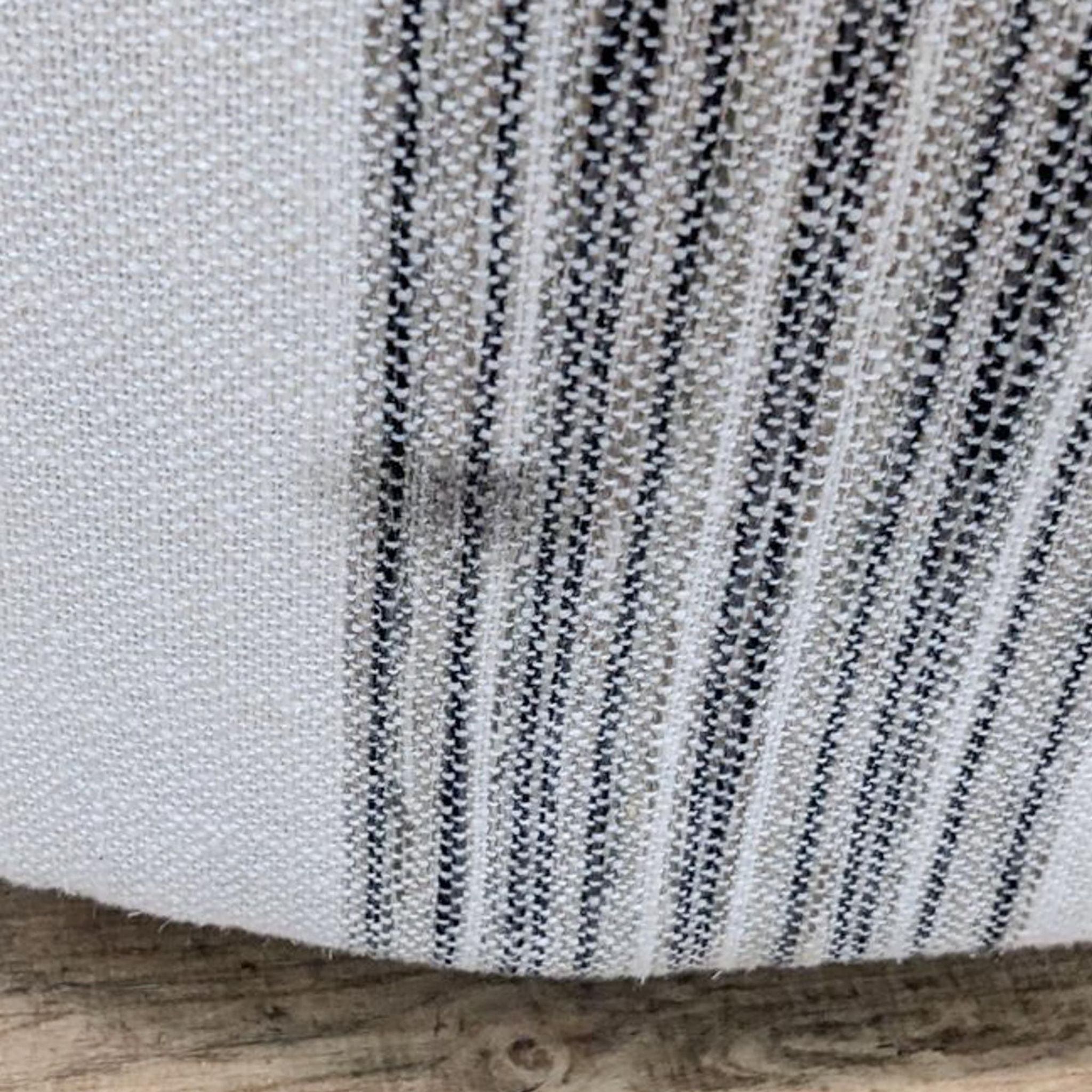 Close-up of the ivory and black fabric upholstery on a Comfort Design swivel chair.