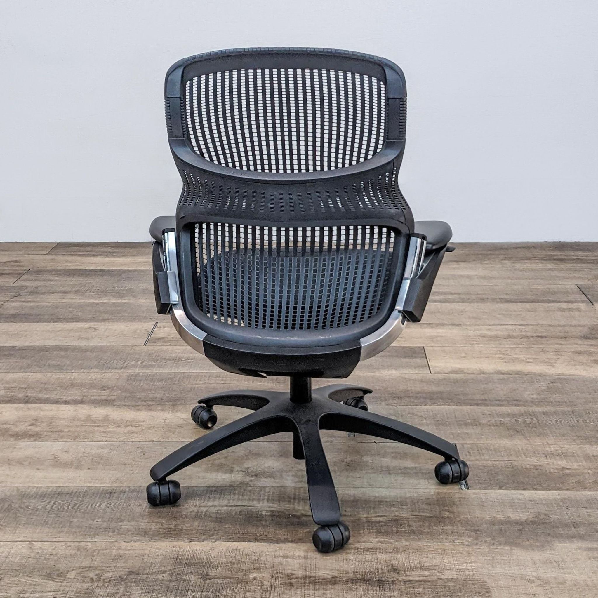 Knoll Generation office chair with figure 8 structure, flex back net, and frameless seat on casters.