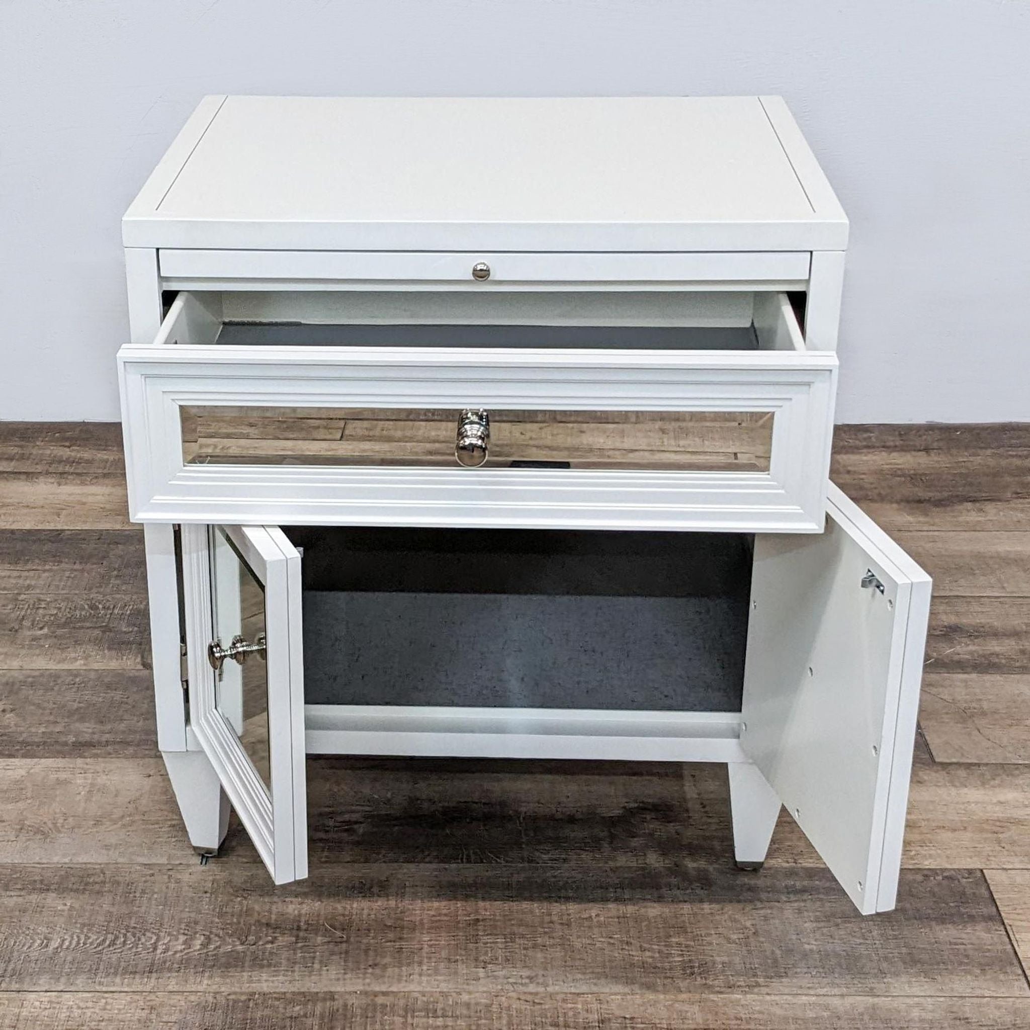 White Z Gallerie end table with mirrored drawer fronts and stepped moulding, showing open cabinet space. 