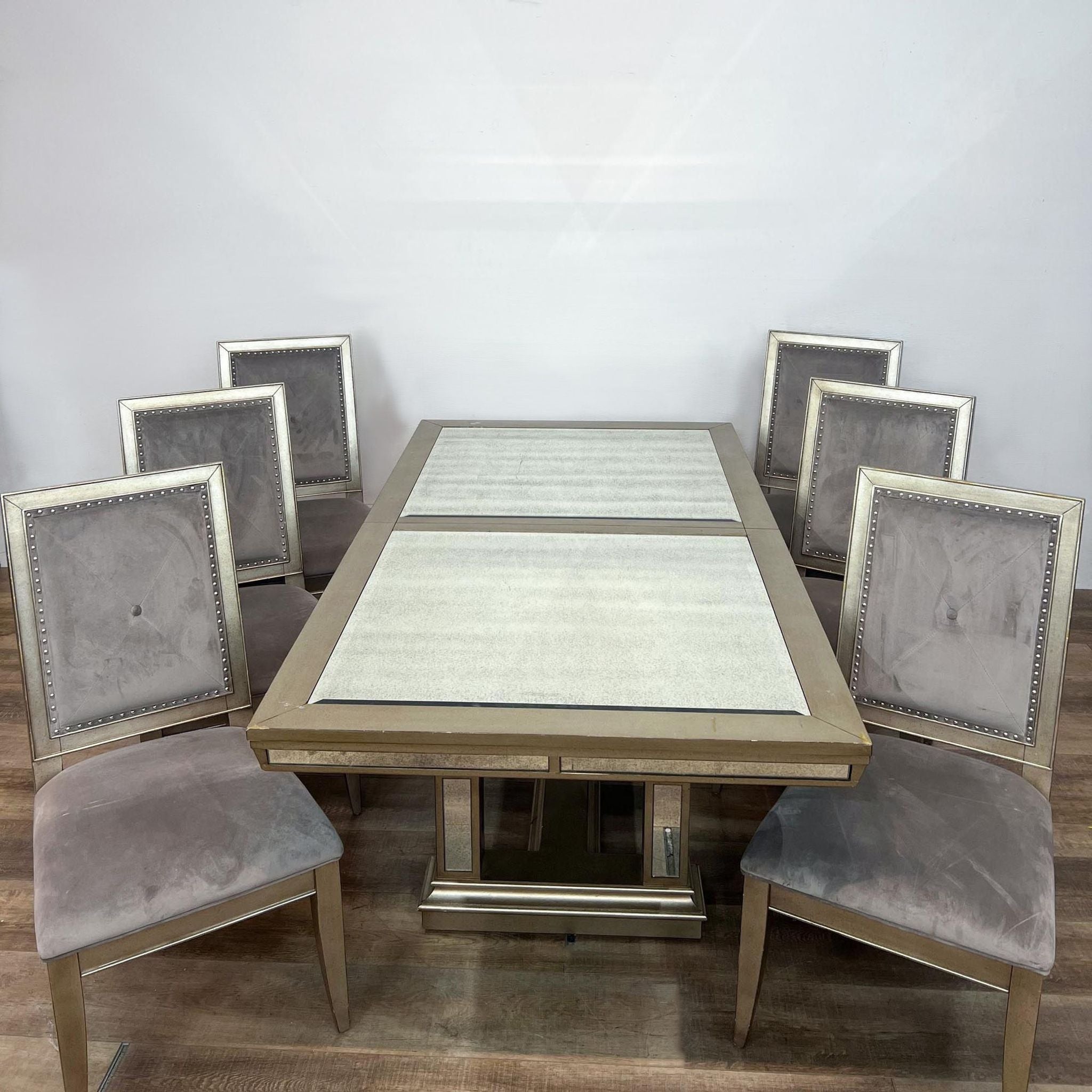 Z-Gallerie Ava expandable dining table with antiqued mirror panels and six tufted grey velvet chairs with nailhead trim.