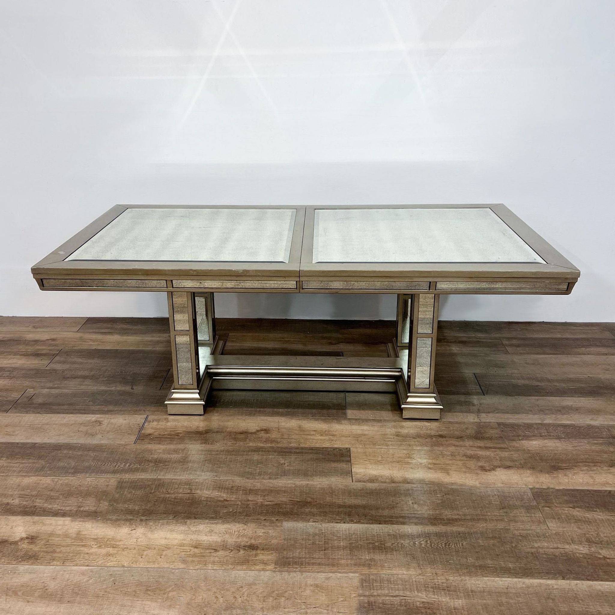 Alt text 2: X-Gallerie dining set featuring an expandable hardwood table with mirrored panels and metallic trim, accompanied by diamond-tufted grey velvet chairs.
