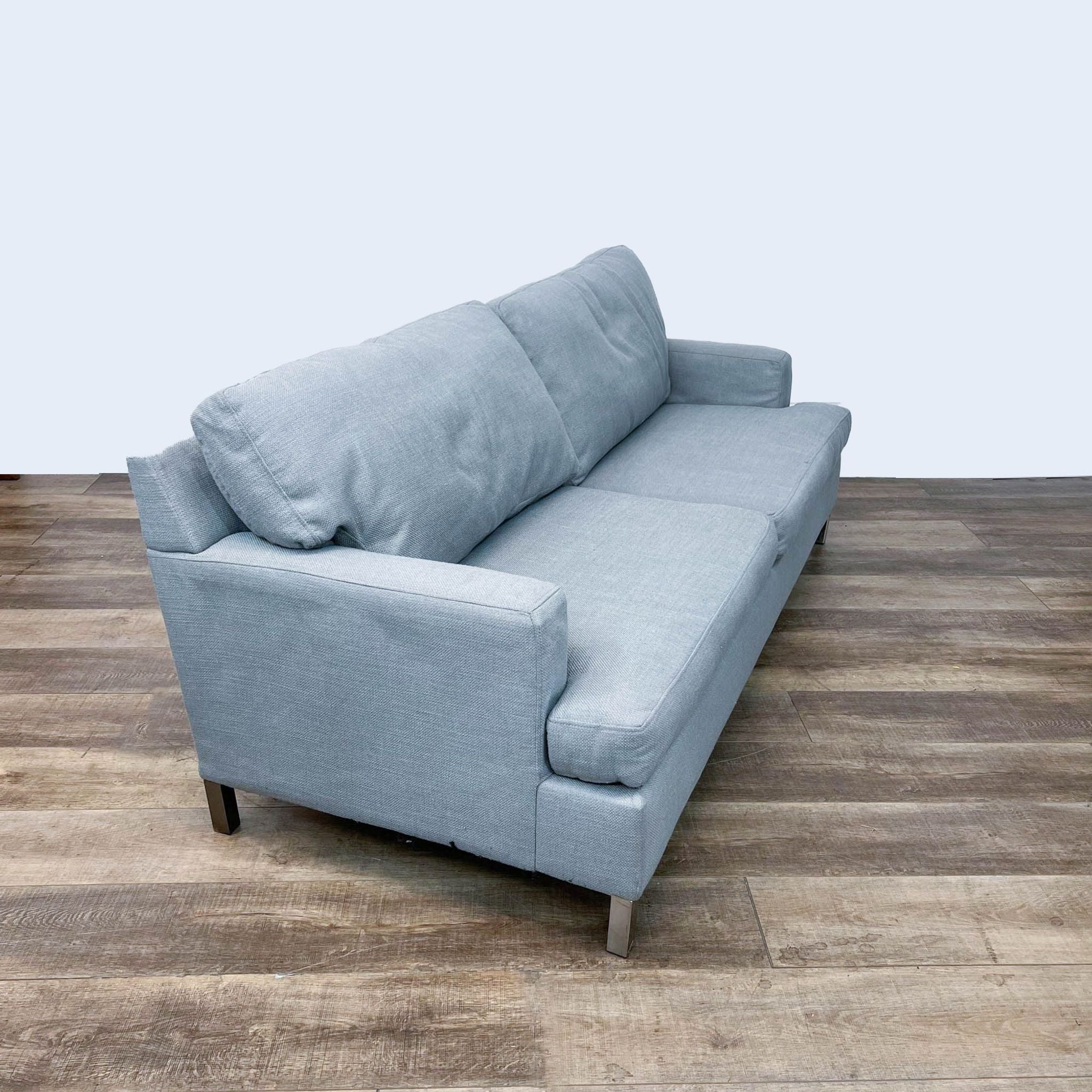Better by Design 3-seat sofa featuring a gray linen texture, modern track arms, and sleek nickel legs.