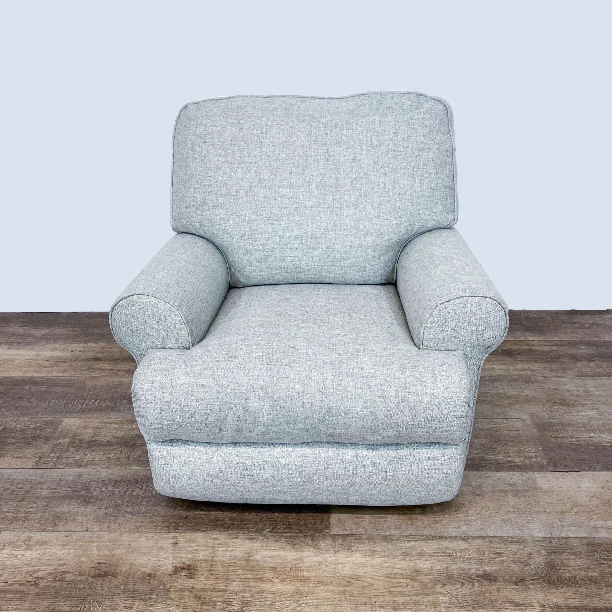 Ashley Furniture Ferncliff chair with neutral polyester upholstery, showcasing a 360-degree swivel and gentle rocking function.