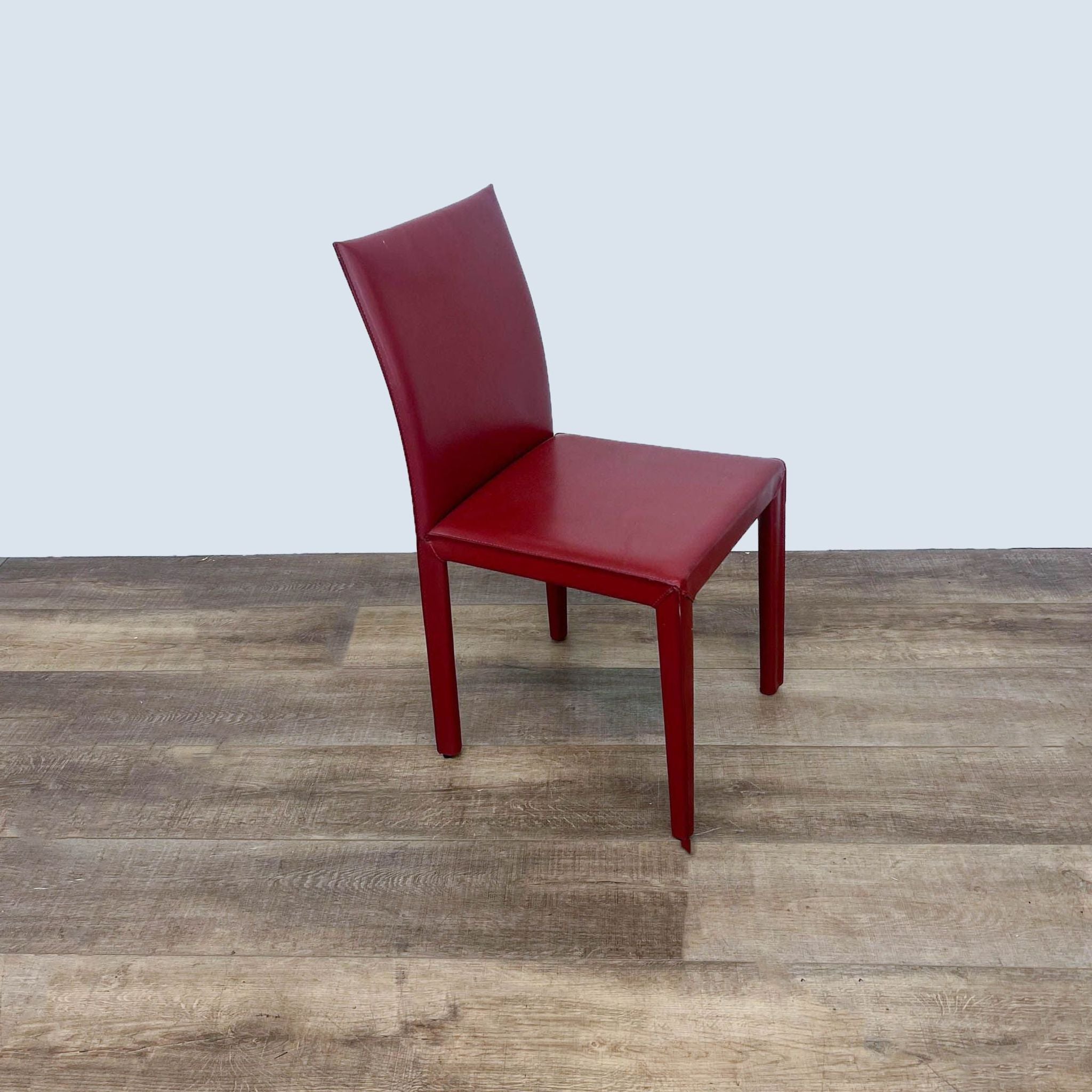 2. Close-up of red bonded leather upholstery on Maria Yee styled dining chair.