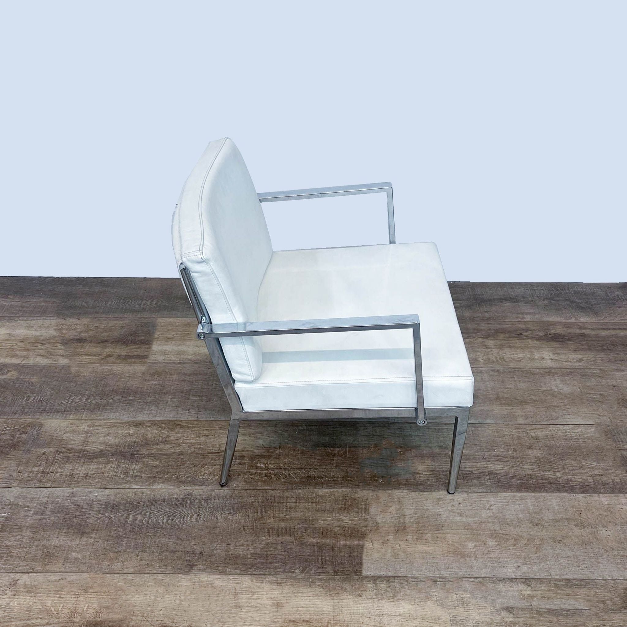 Reperch contemporary white leather lounge chair with chrome frame; angled view showing slight curvature of the backrest.
