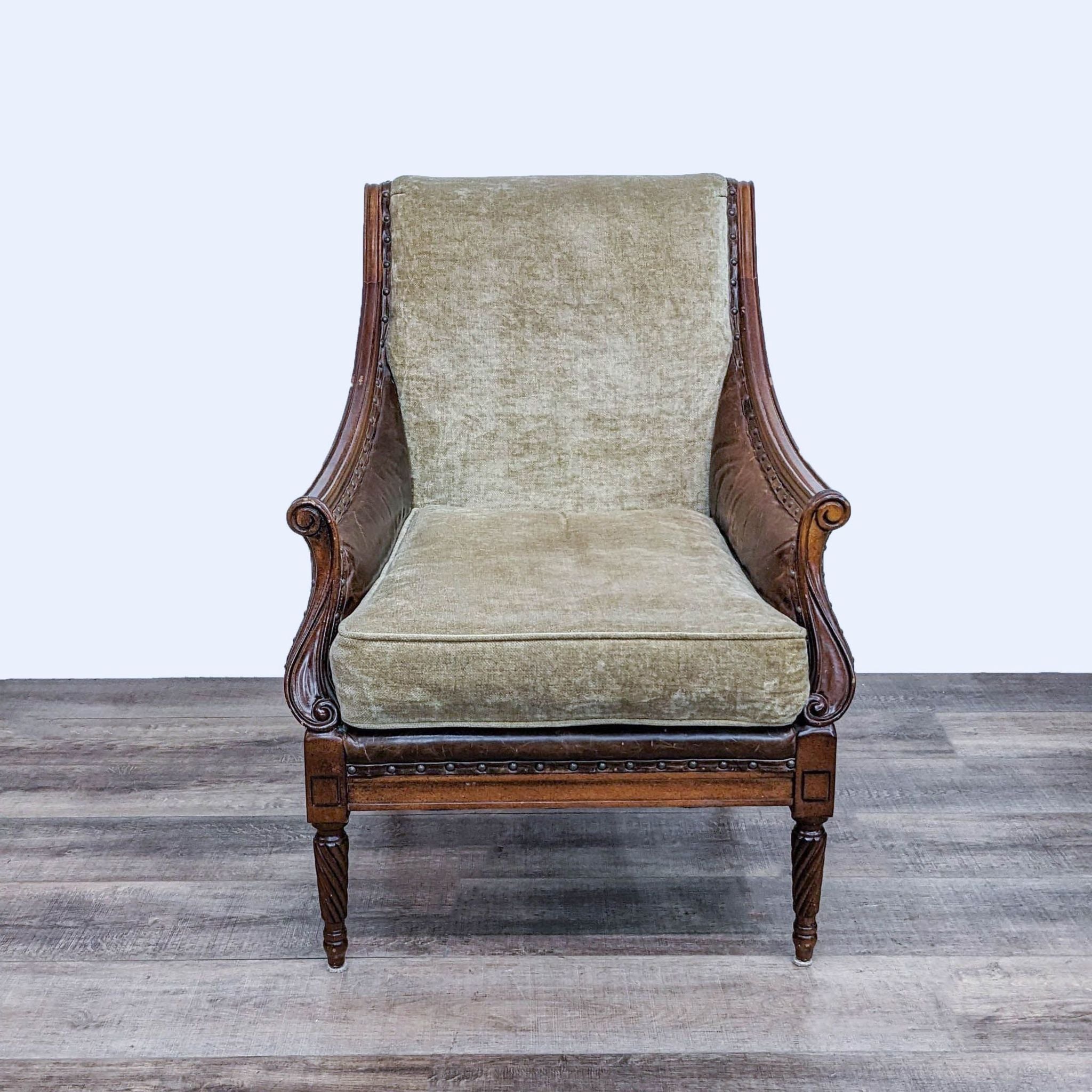 Front view of a Robert Allen armchair with rolled arms, textured fabric, leather trim, and walnut wood frame.