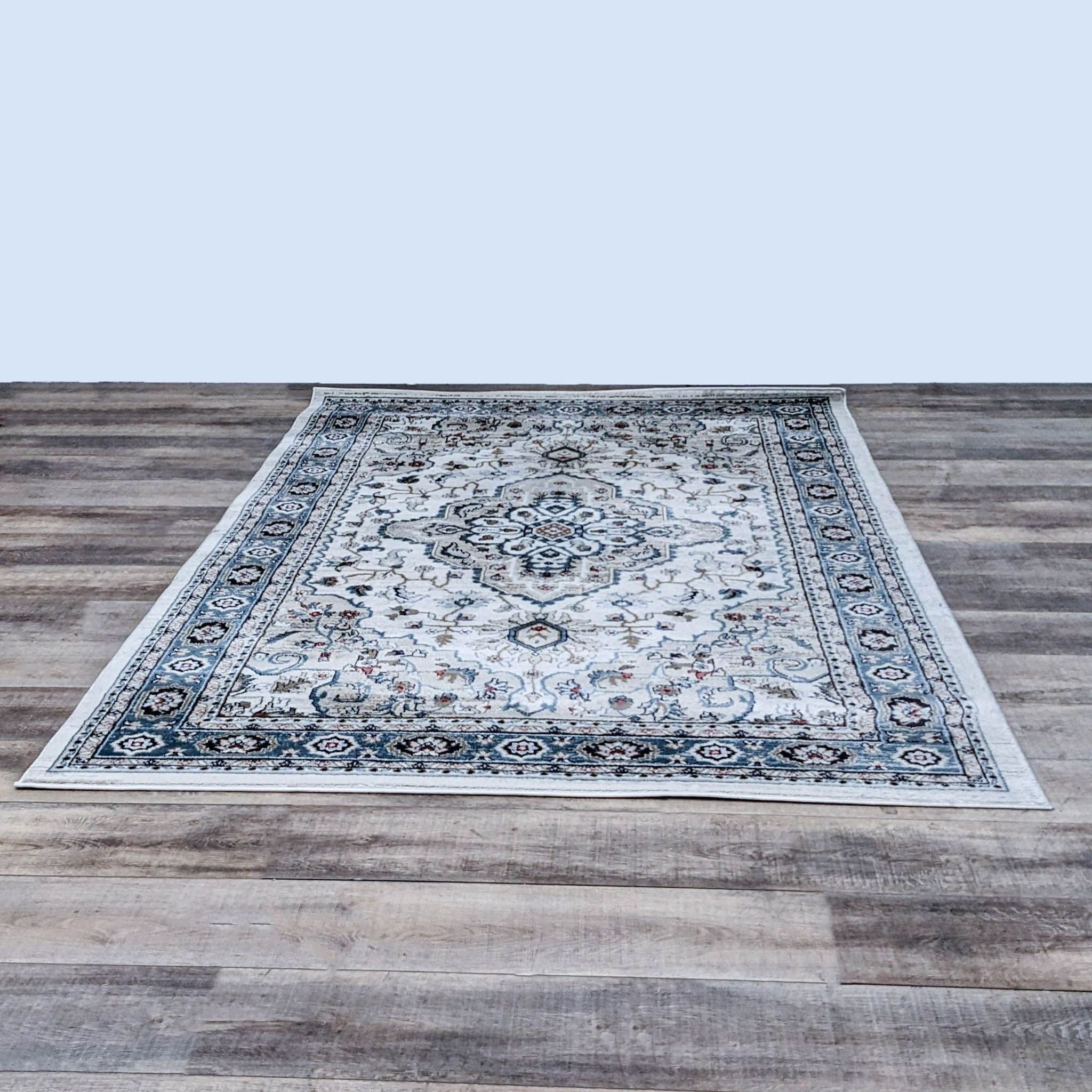 Reperch branded 6'x9' area rug with central medallion and intricate floral patterns on a wooden floor.
