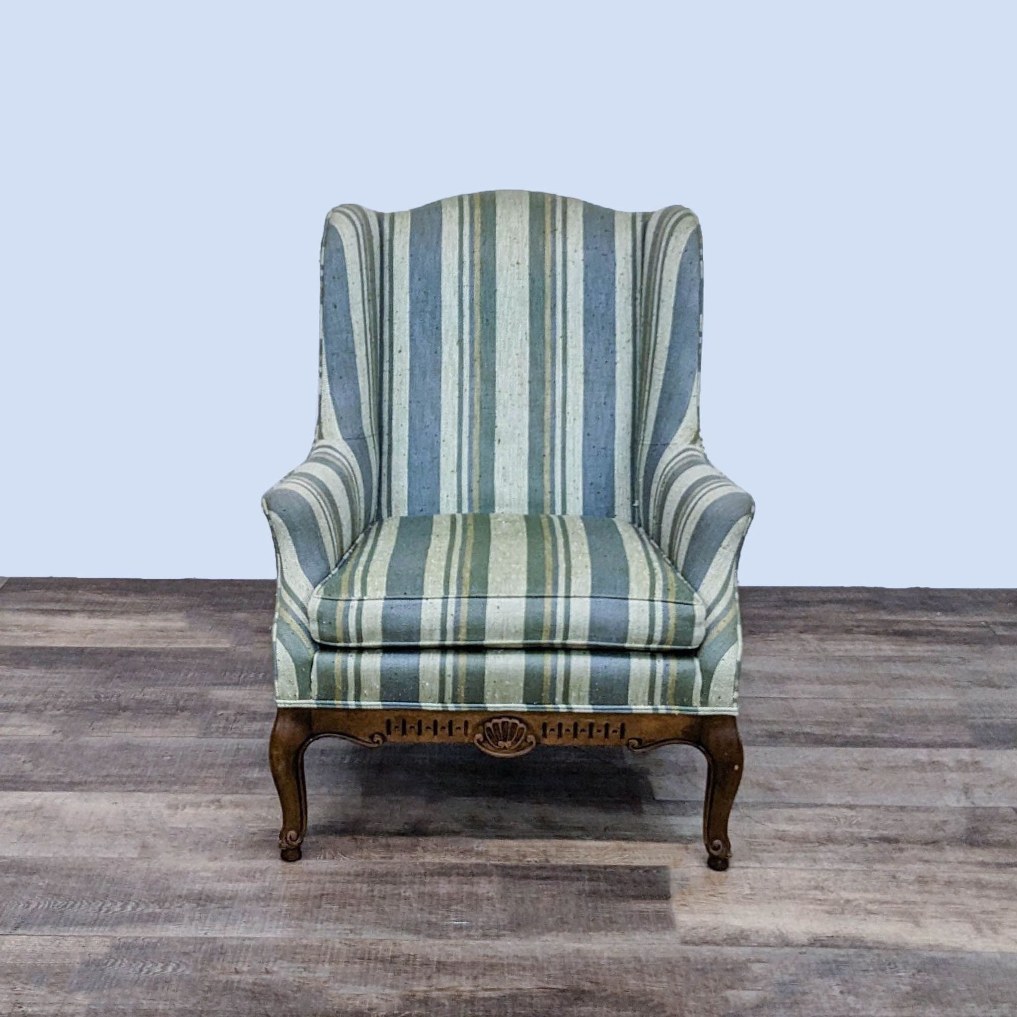 Front view of a Reperch contemporary wingback chair with striped Scotchguard fabric and decorative wood trim.