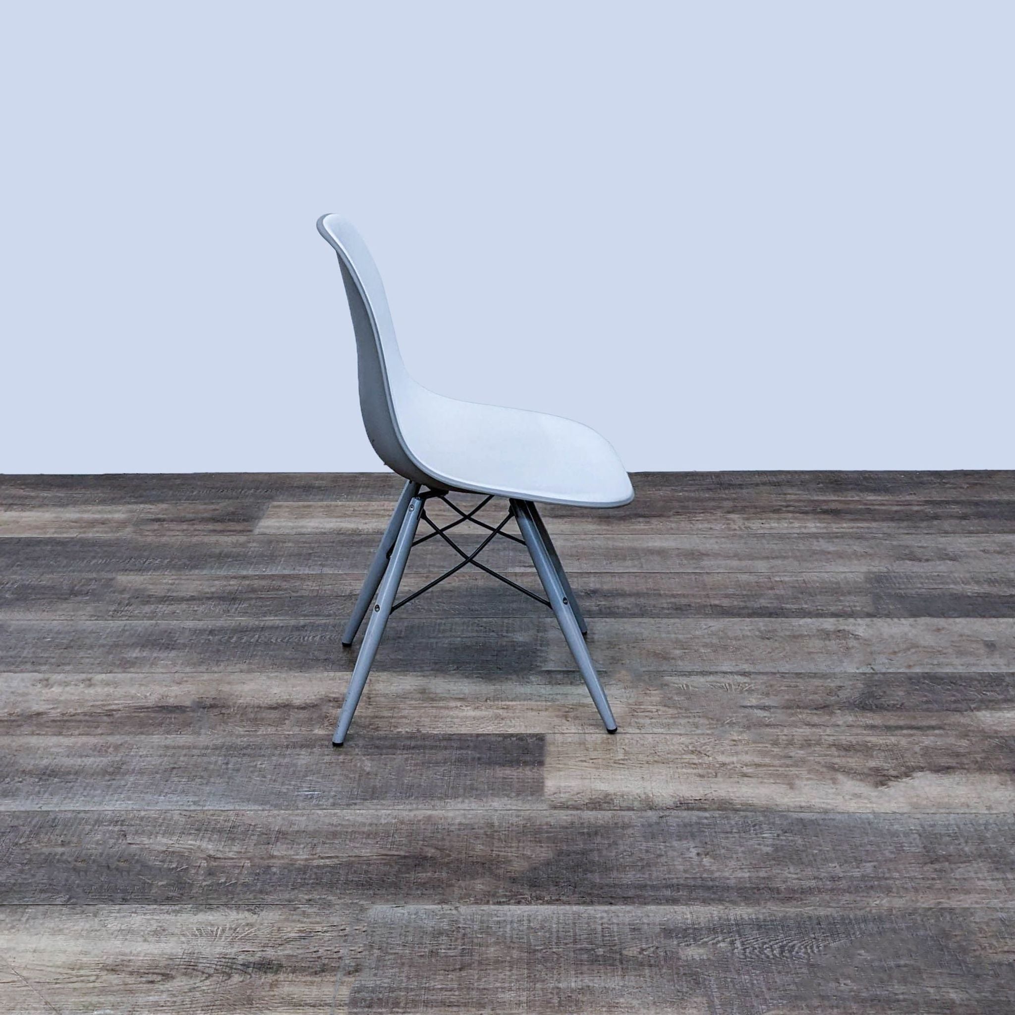 Modern side chair by Reperch with grey and white two-toned design and Eiffel base, displayed against a neutral background.