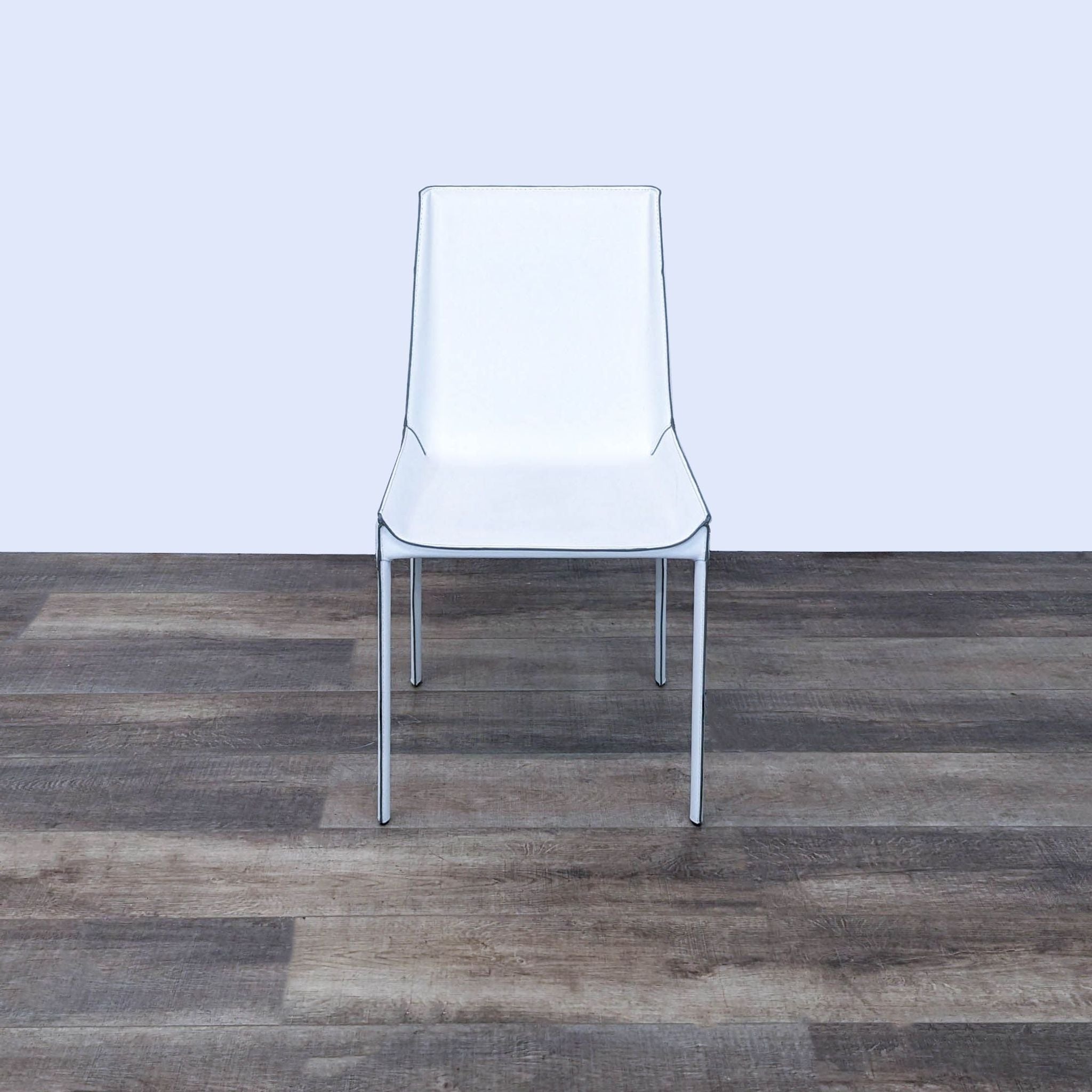 Zuo Modern slim profile Fashion dining chair with recycled leather and exposed seams, high back and metal legs, on wooden floor.