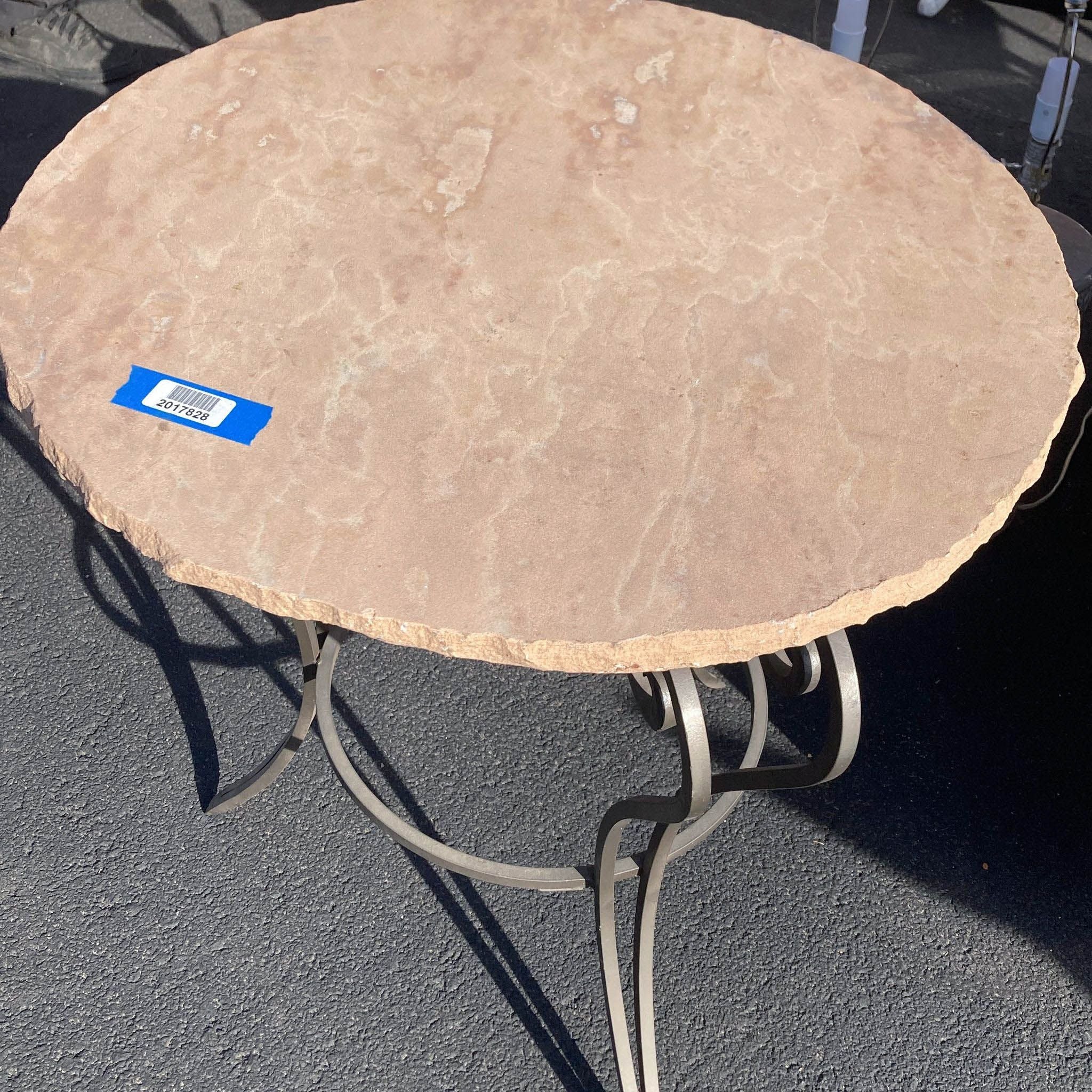 Round Reperch tabletop with textured beige surface and curved metal base, blue sticker visible.